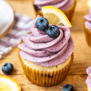 Cupcakes on cutting board with blueberry frosting
