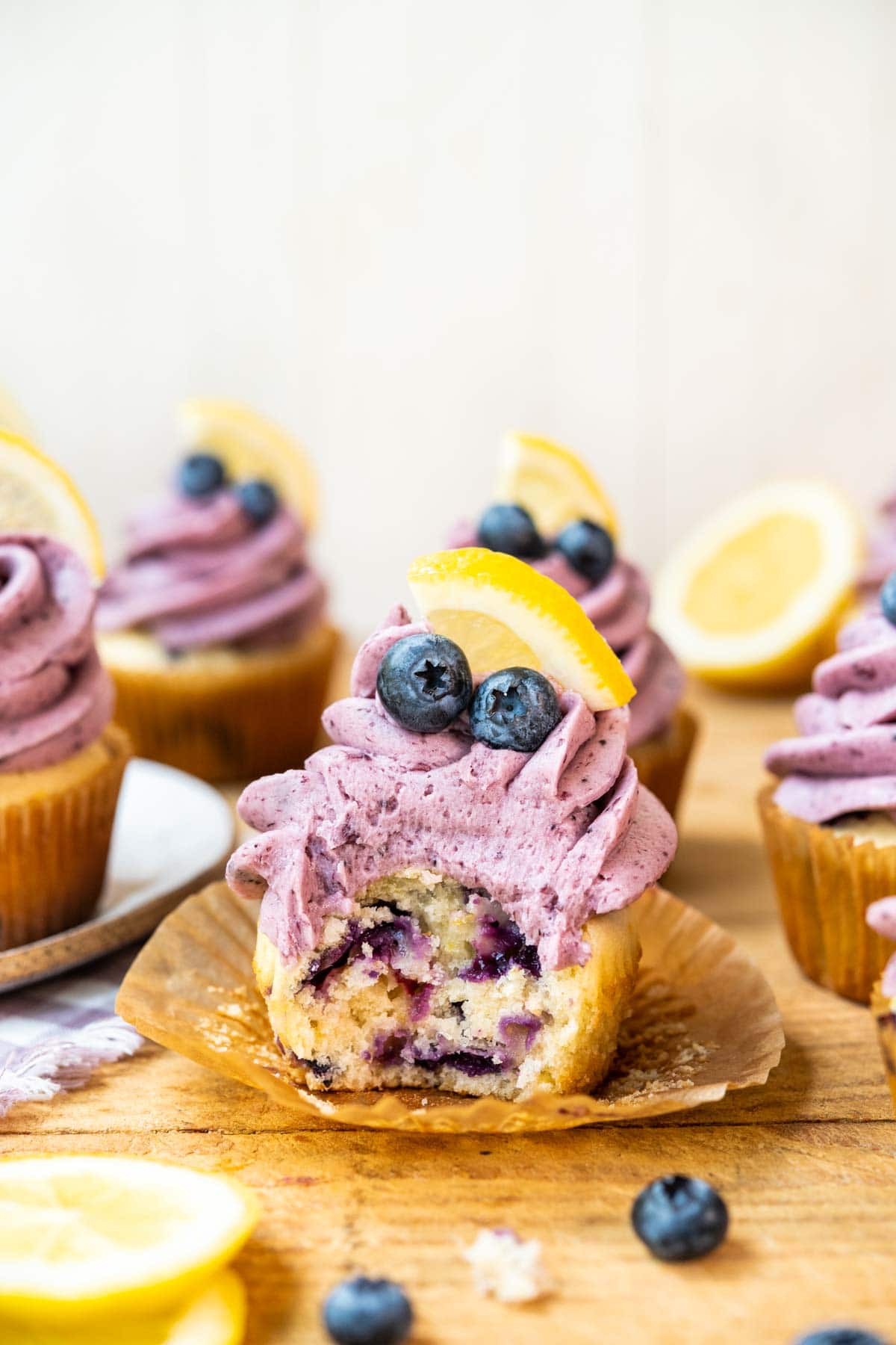 Blueberry Lemon Cupcakes on cutting board with blueberry frosting