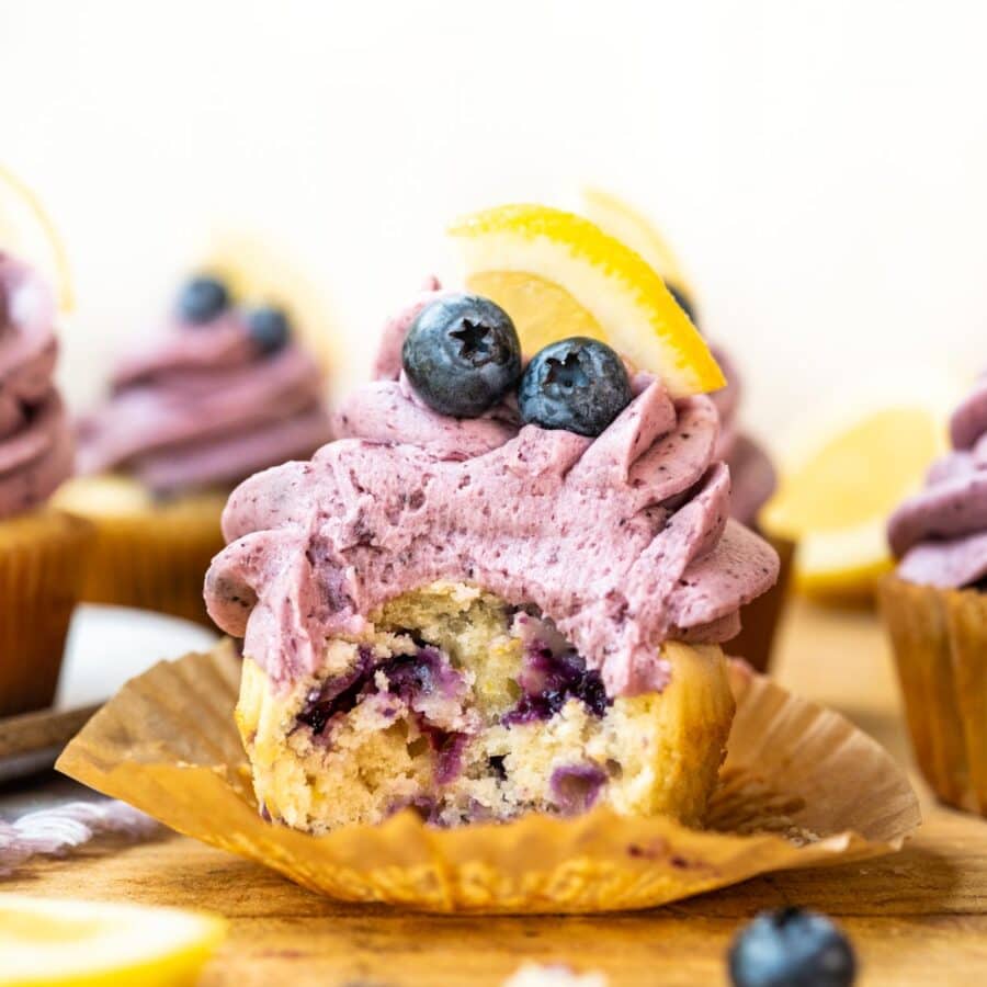 Blueberry Lemon Cupcakes on cutting board with blueberry frosting