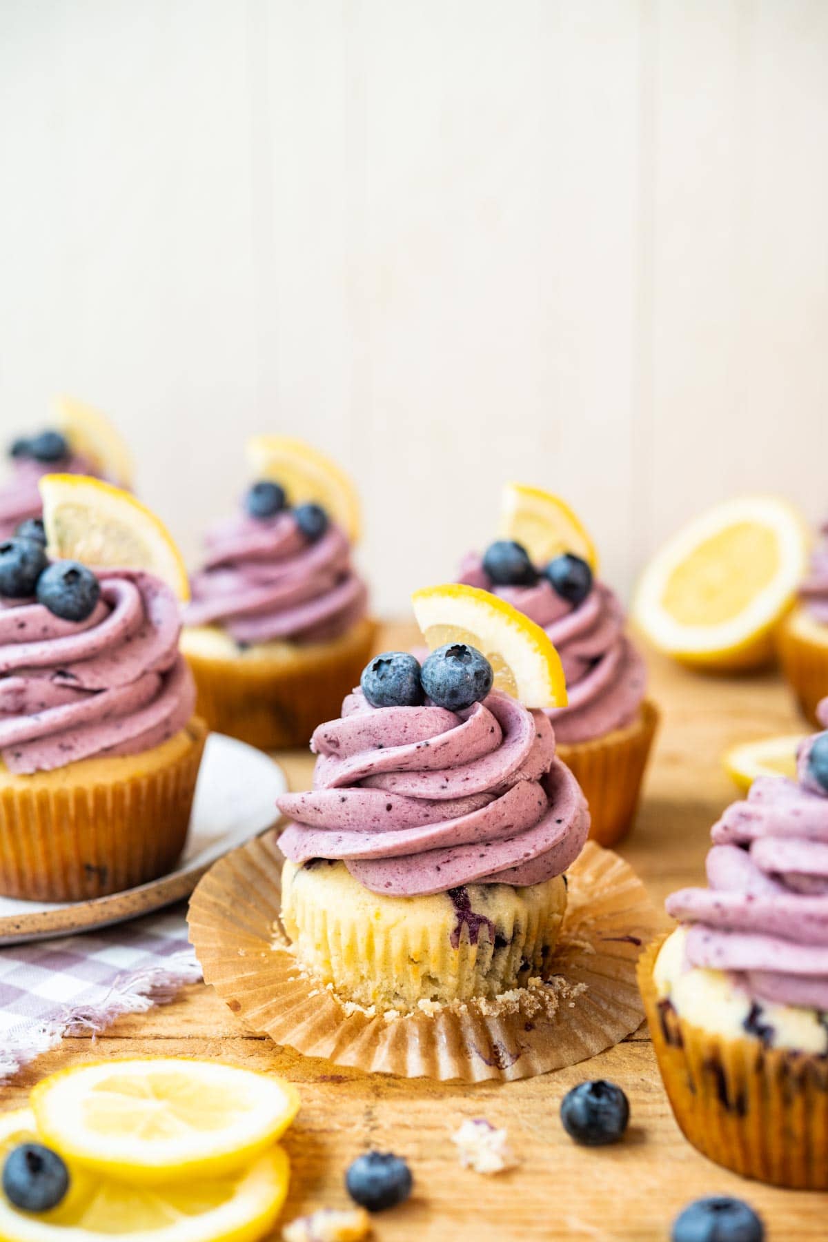 Blueberry Lemon Cupcakes on cutting board with blueberry frosting