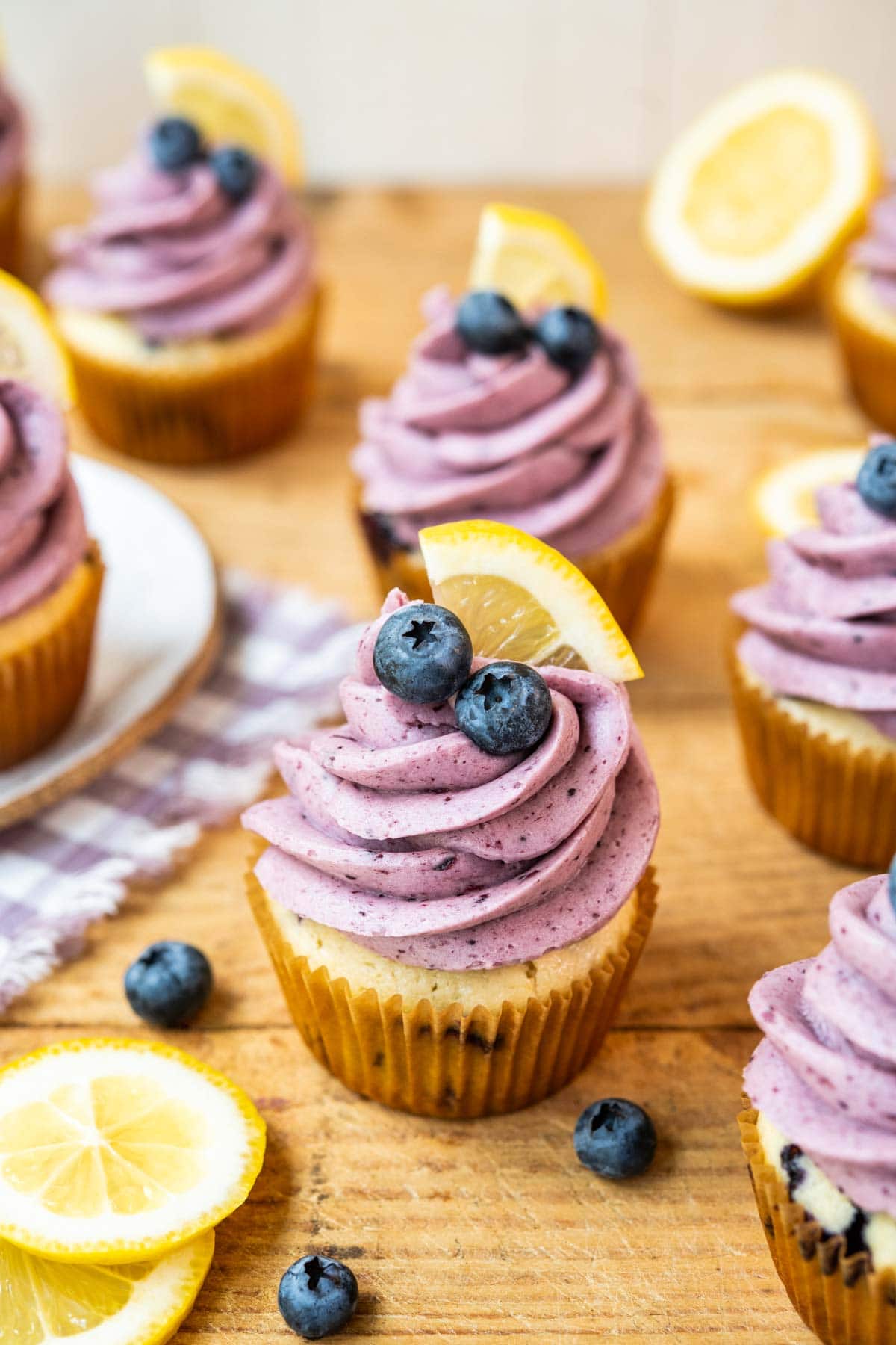 Blueberry Lemon Cupcakes on cutting board with blueberry frosting