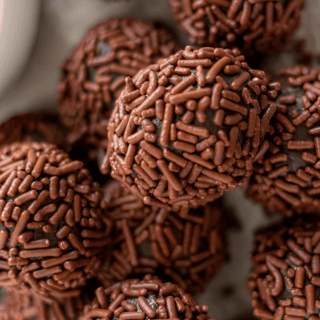 stacked circular chocolate desserts covered in sprinkles