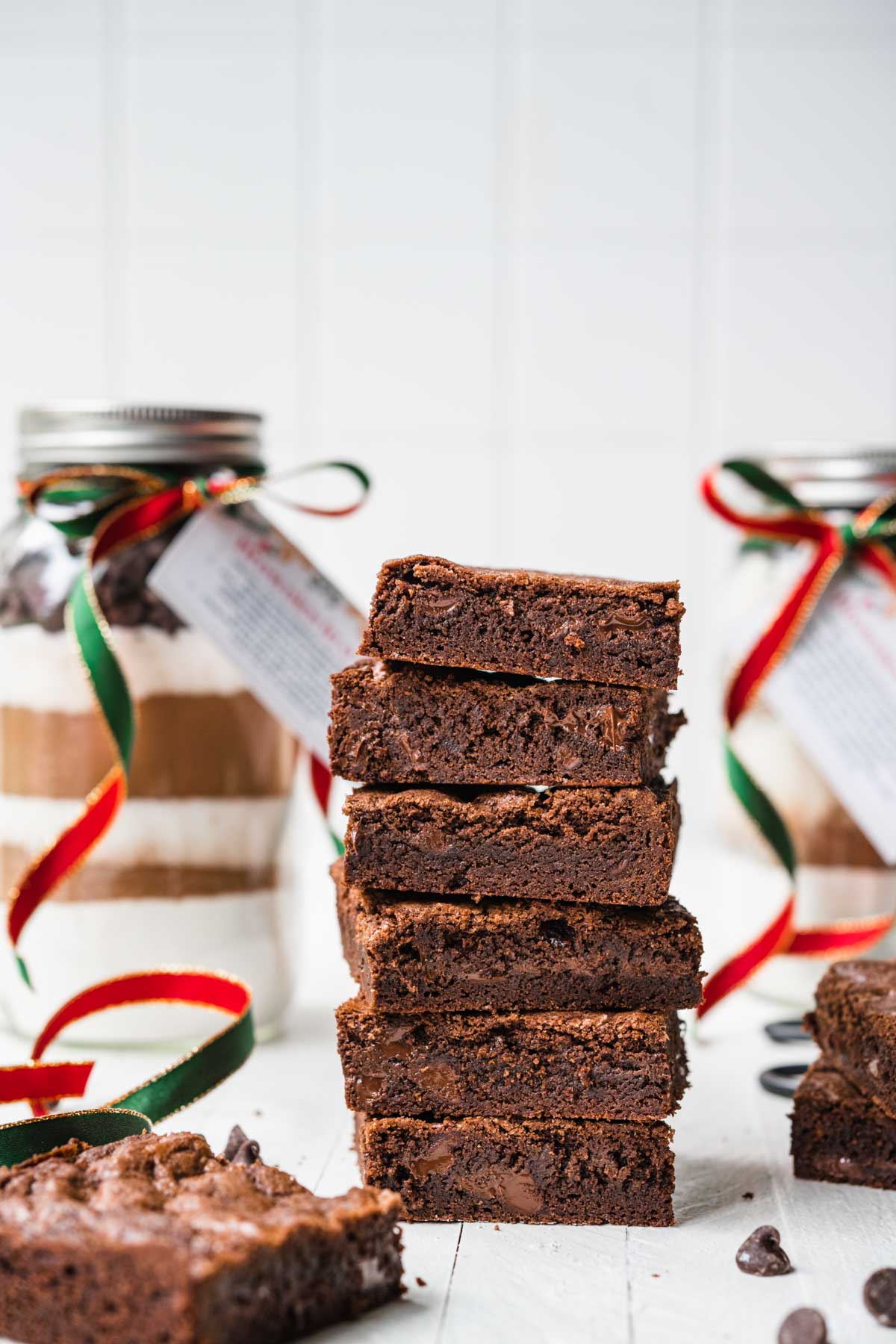 Brownies in a Jar with layered ingredients next to finished baked brownies