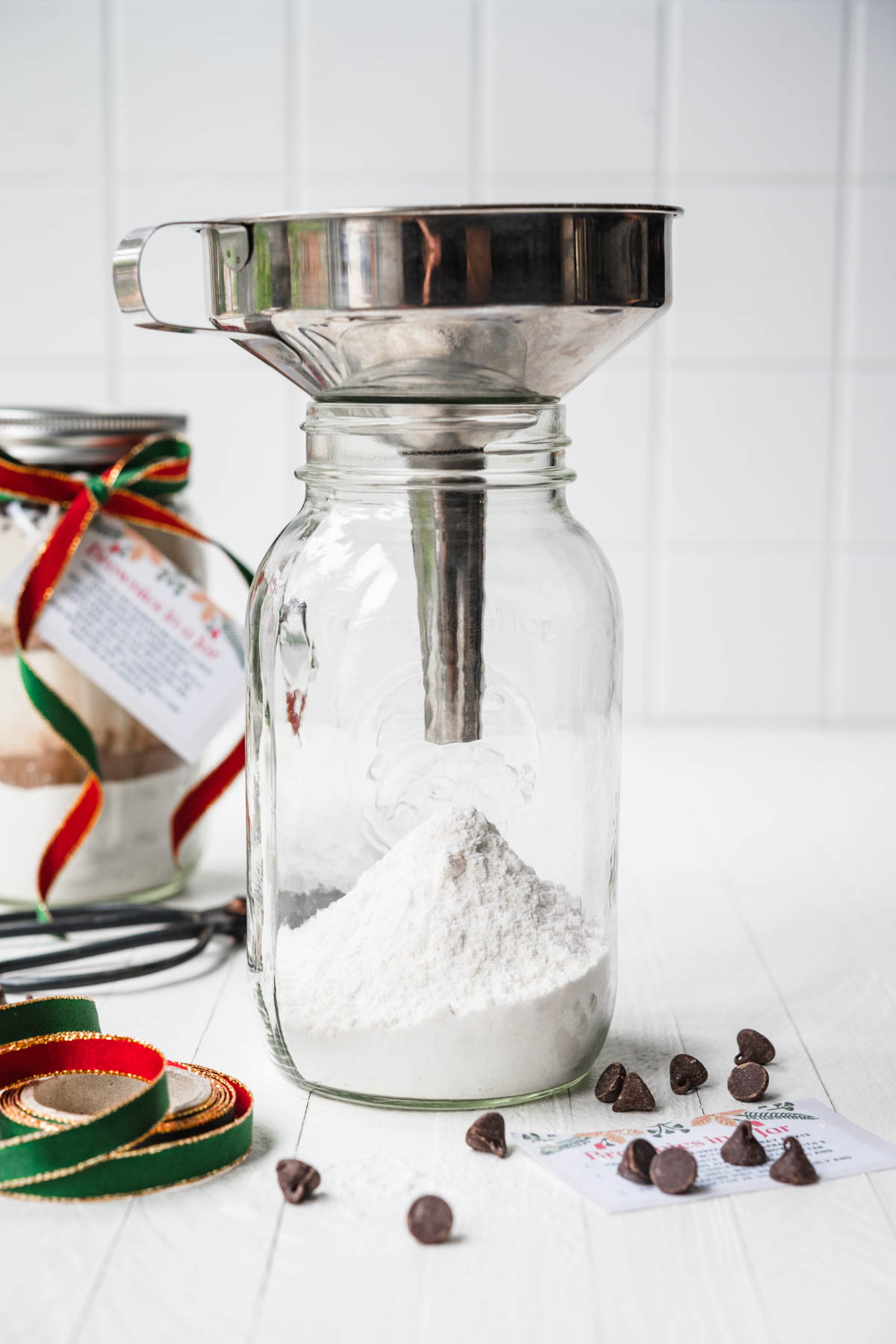 Funnel with Mason jar to fill ingredients for Brownies in a Jar