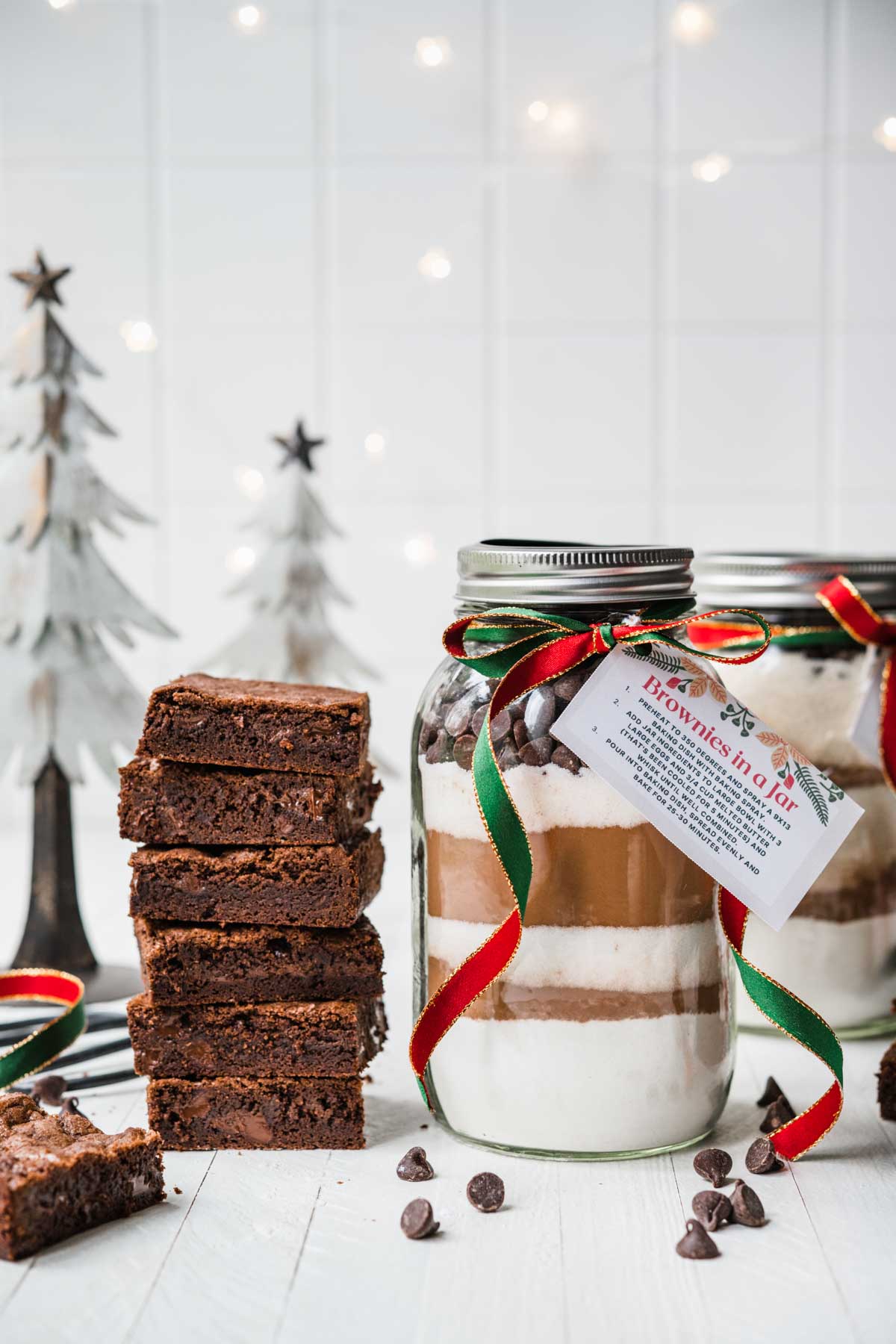 Brownies in a Jar with layered ingredients next to finished baked brownies