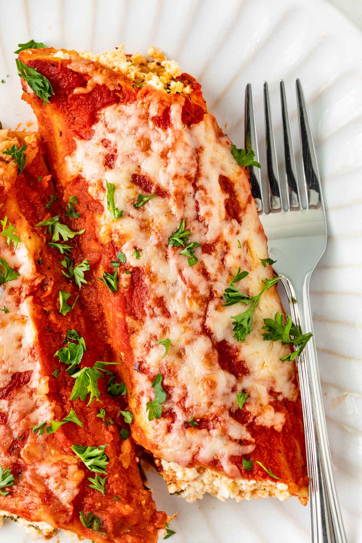 Cheesy Manicotti on plate with fork