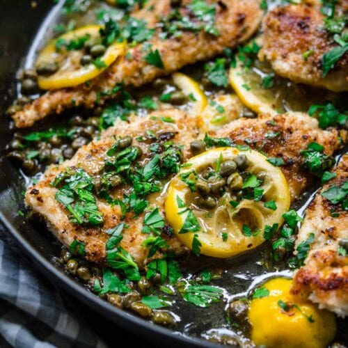Close up of Chicken Piccata in pan with lemon and parsley