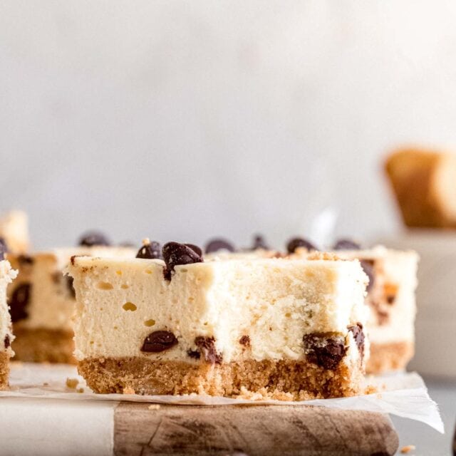 Close up of Chocolate Chip Cheesecake Bars on cutting board