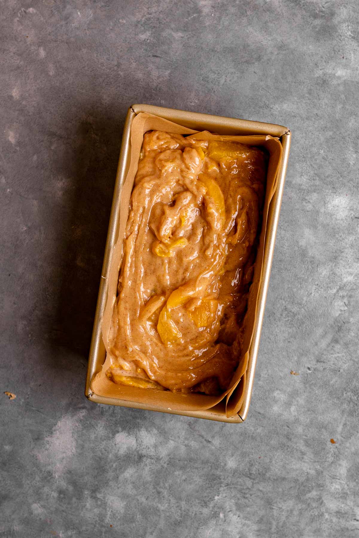 Cinnamon Peach Bread batter in loaf pan