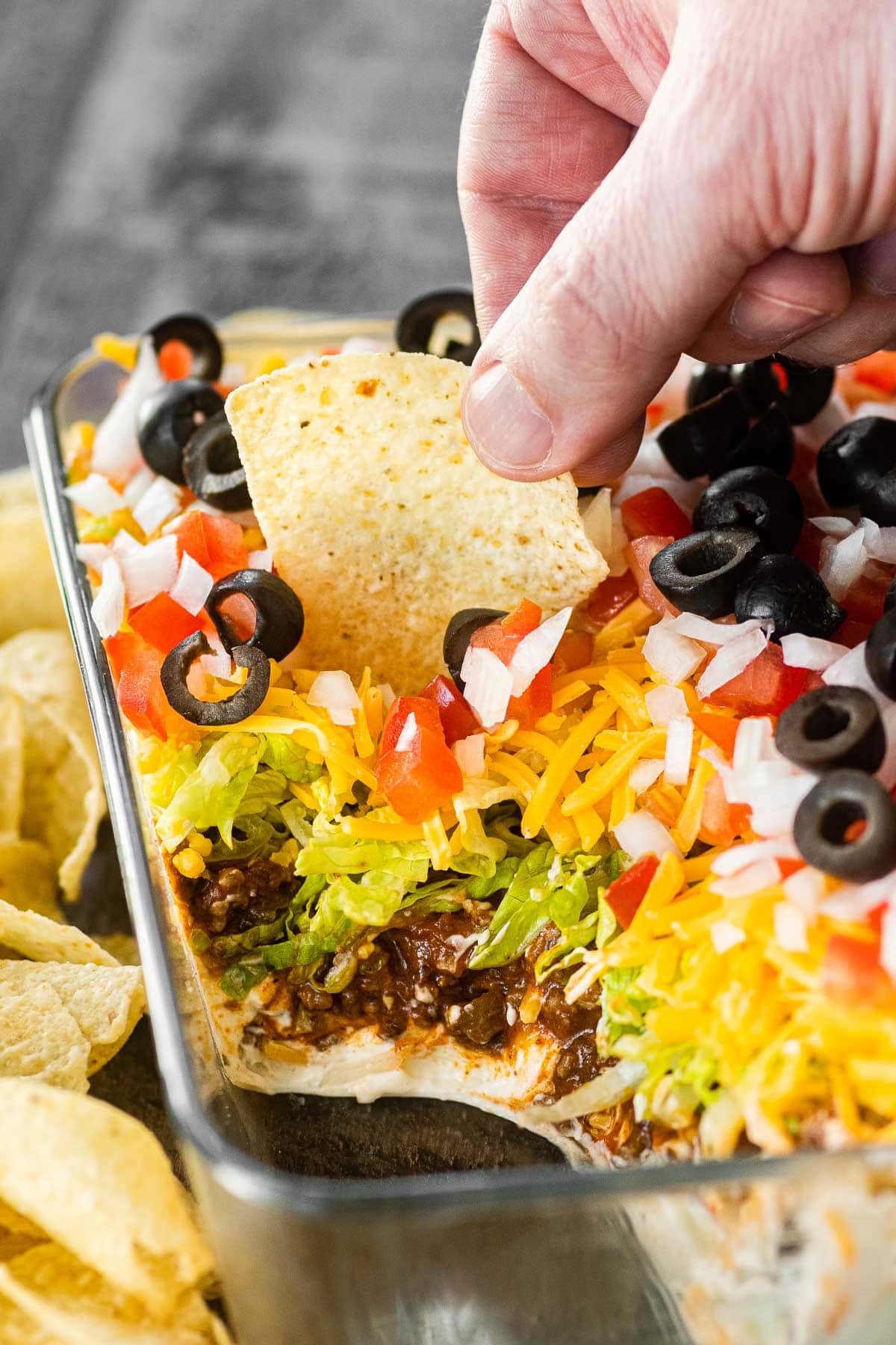 Creamy Layer Taco Dip in pan served with tortilla chips