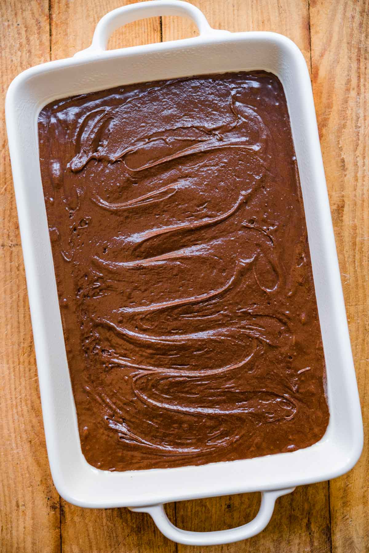 Brownie batter in baking dish for Crispy Chocolate Peanut Butter Brownie Bars