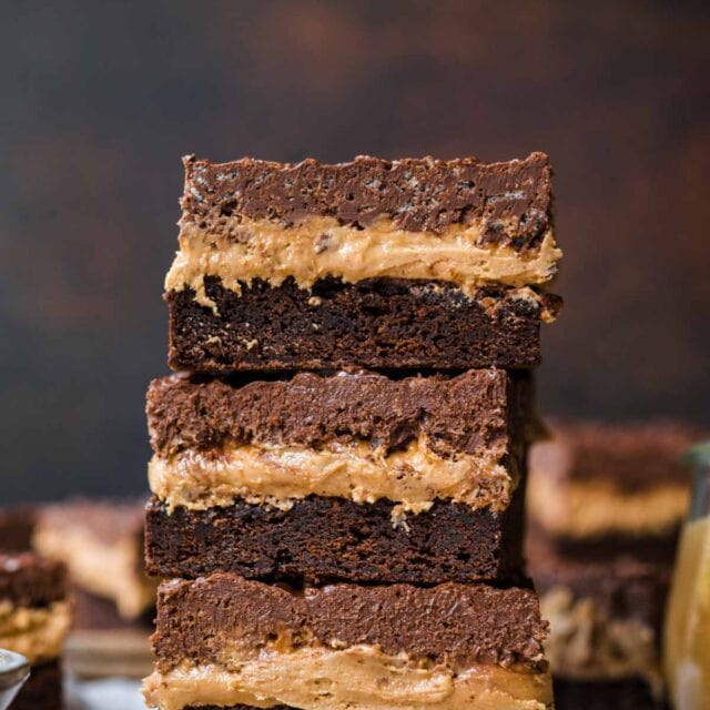 Stacked Crispy Chocolate Peanut Butter Brownie Bars on cutting board