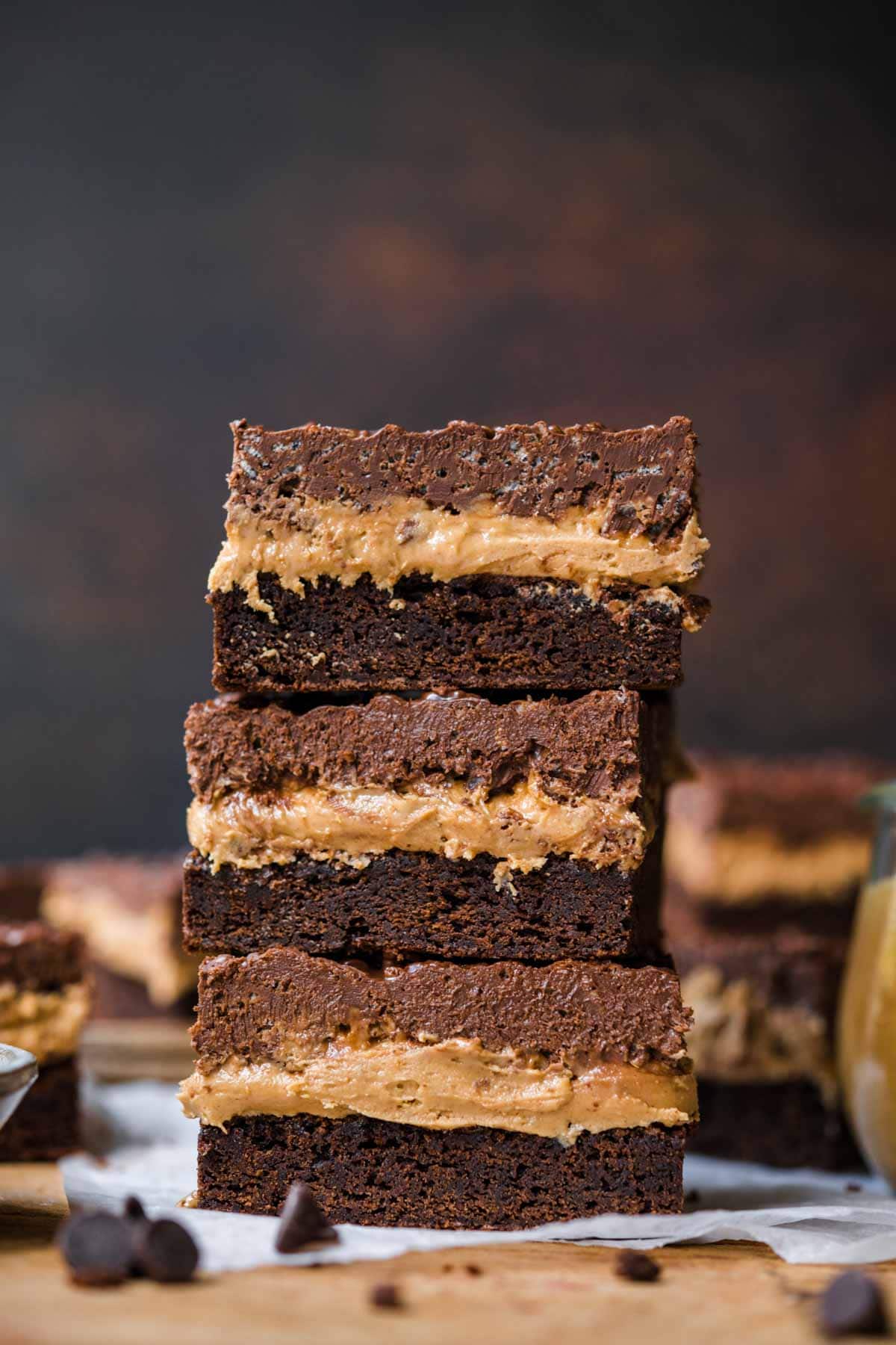 Stacked Crispy Chocolate Peanut Butter Brownie Bars on cutting board