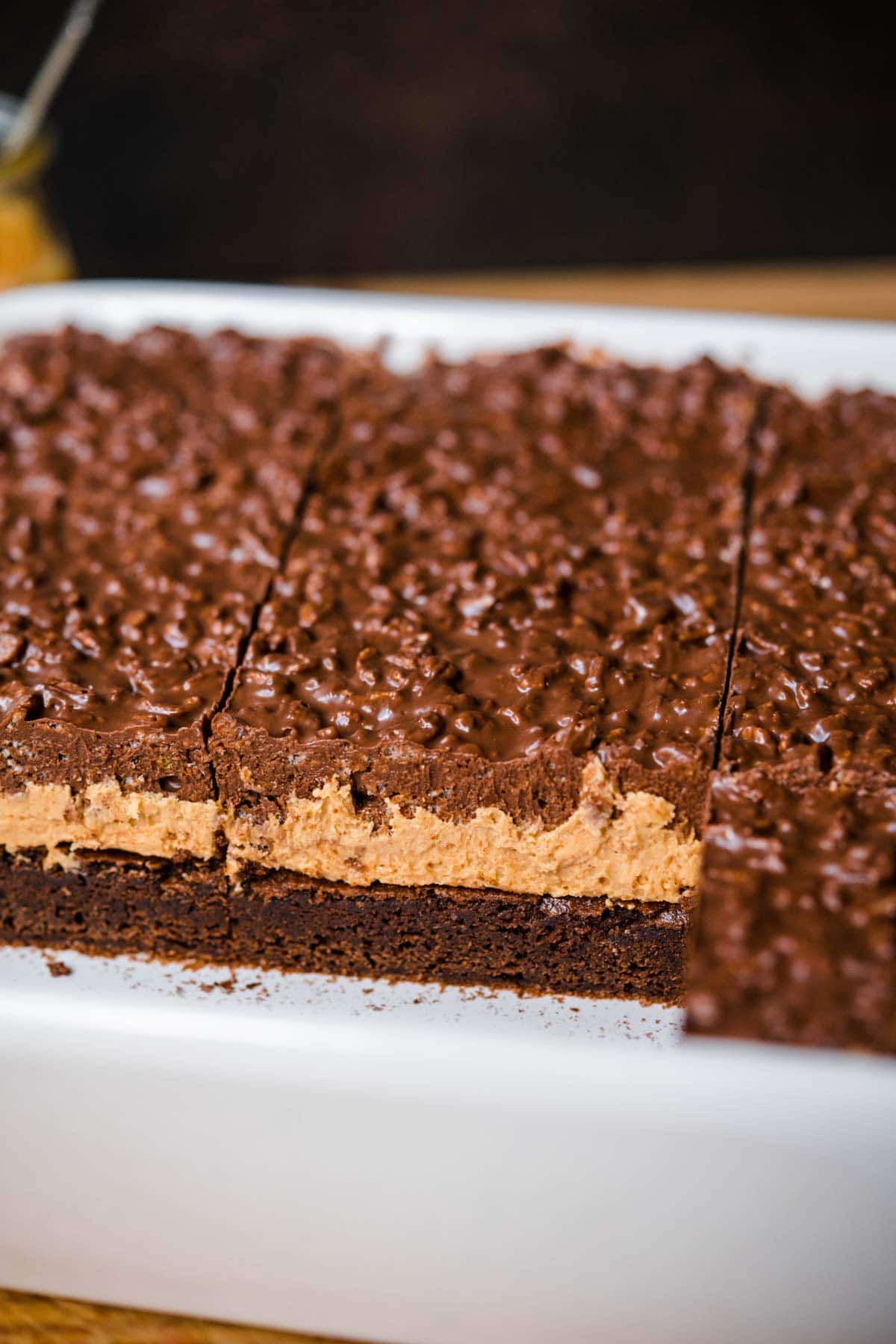 Side view of Crispy Chocolate Peanut Butter Brownie Bars with three layers