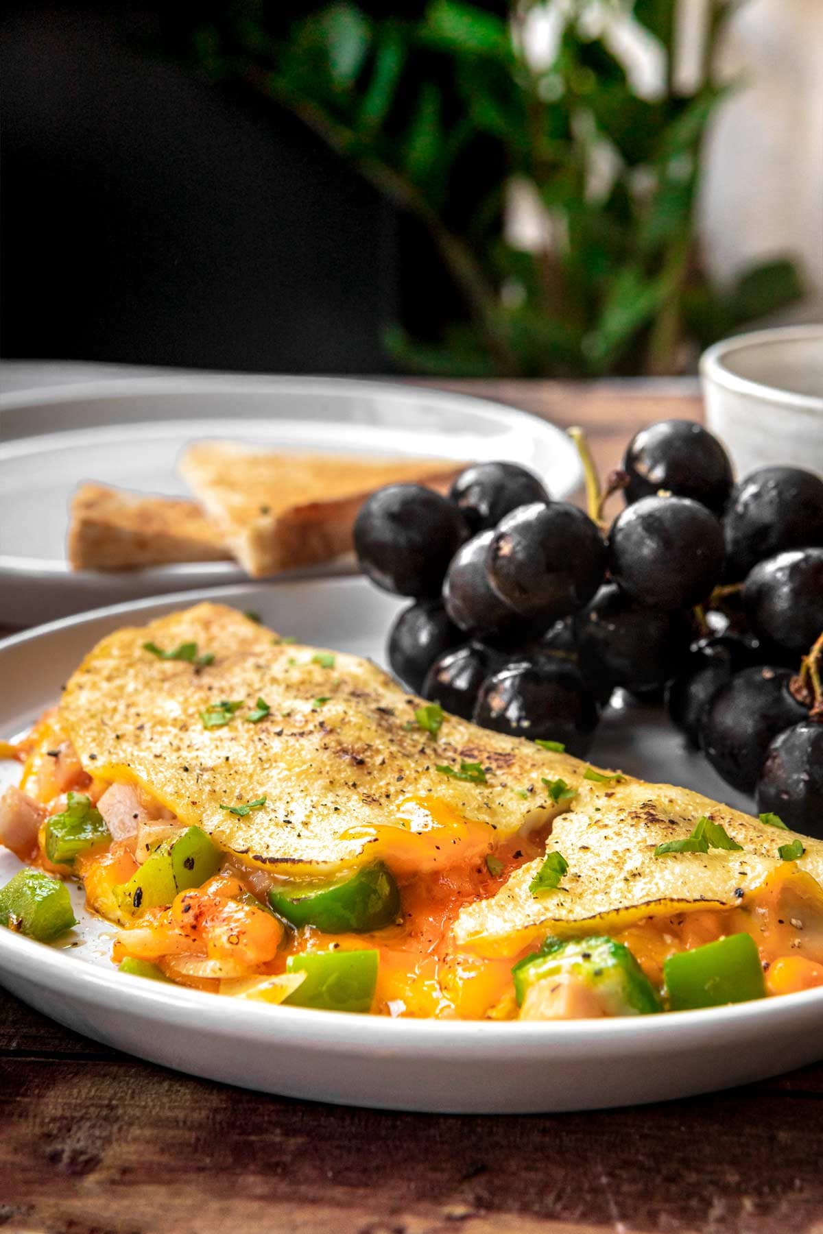 Denver Omelette on plate with black grapes