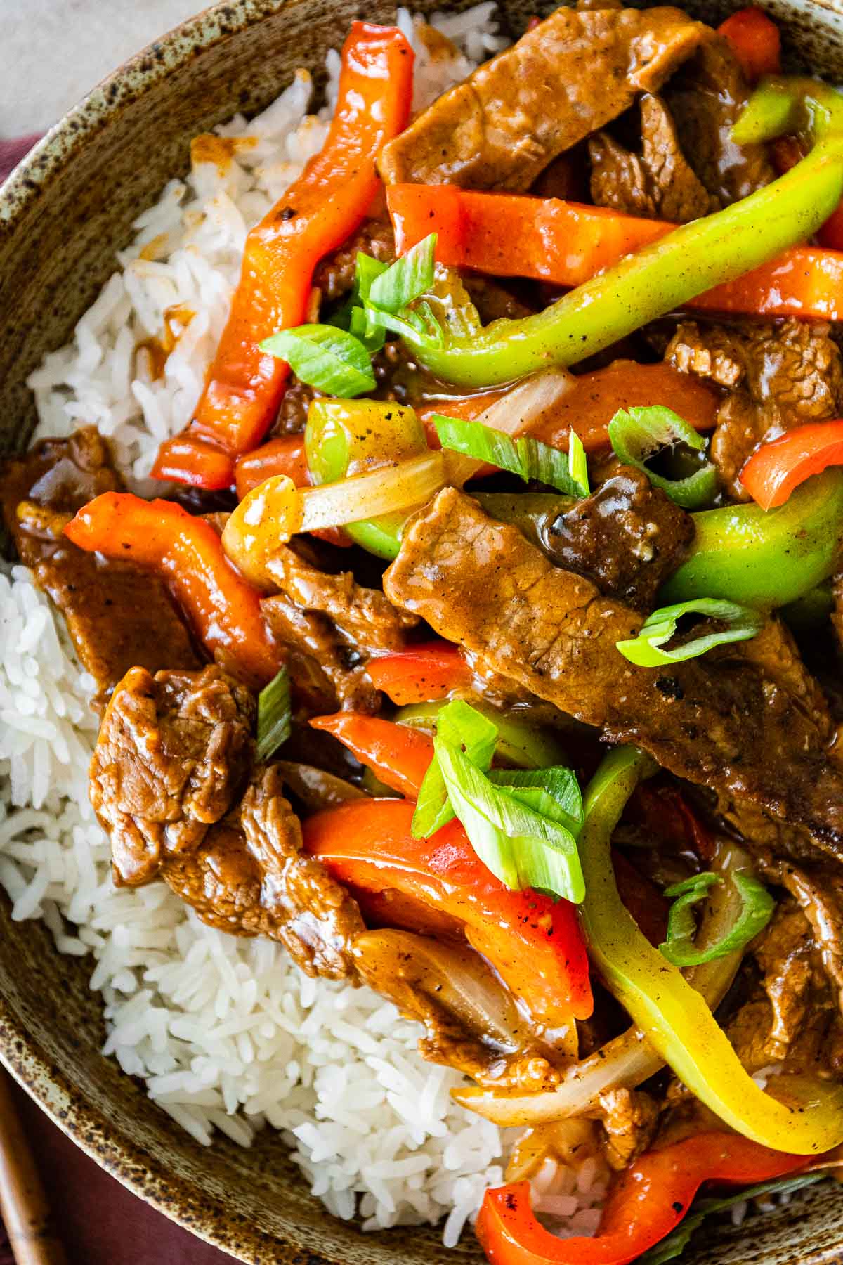 Easy Pepper Steak served over white rice in bowl