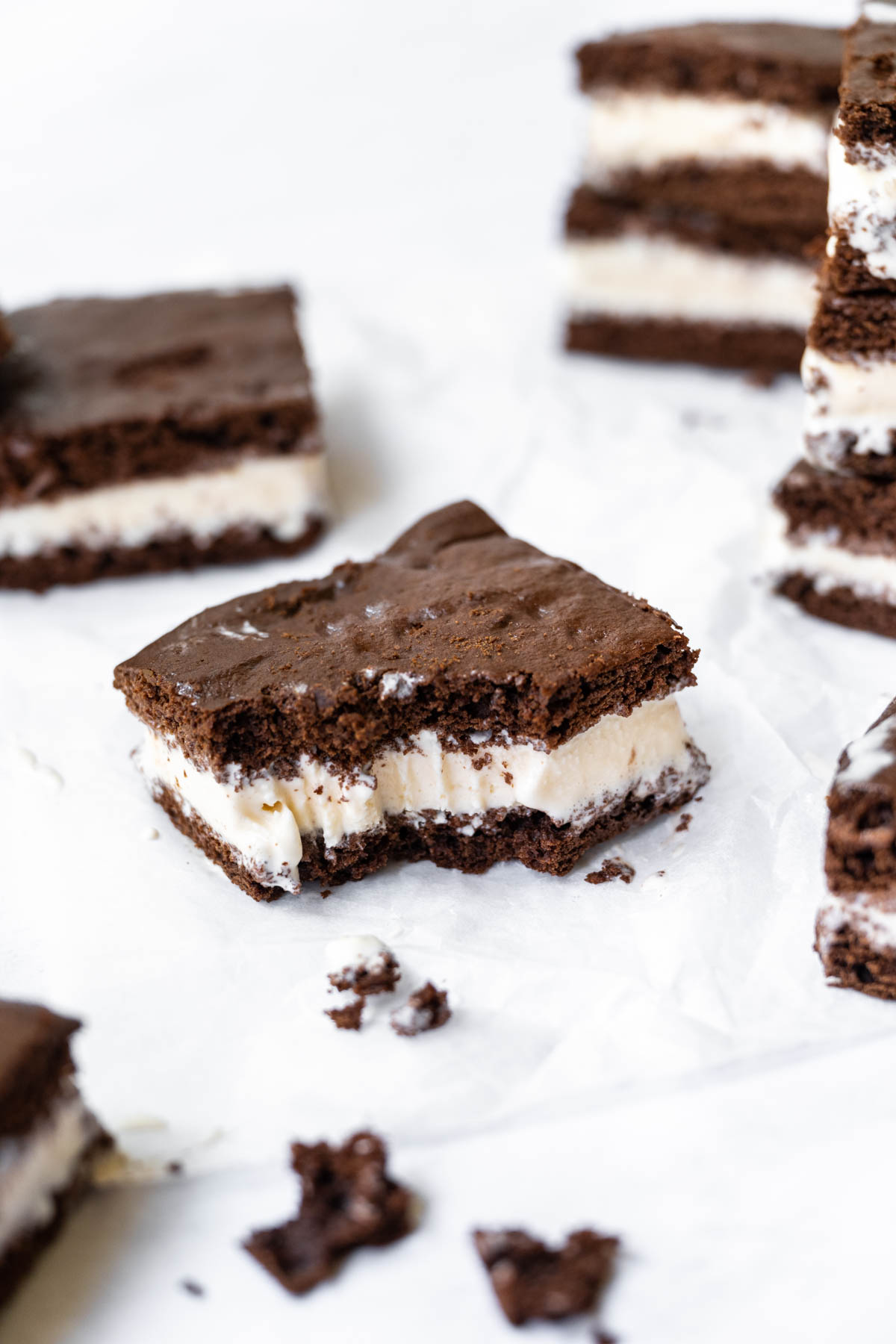 Ice Cream Sandwiches on parchment with bite taken