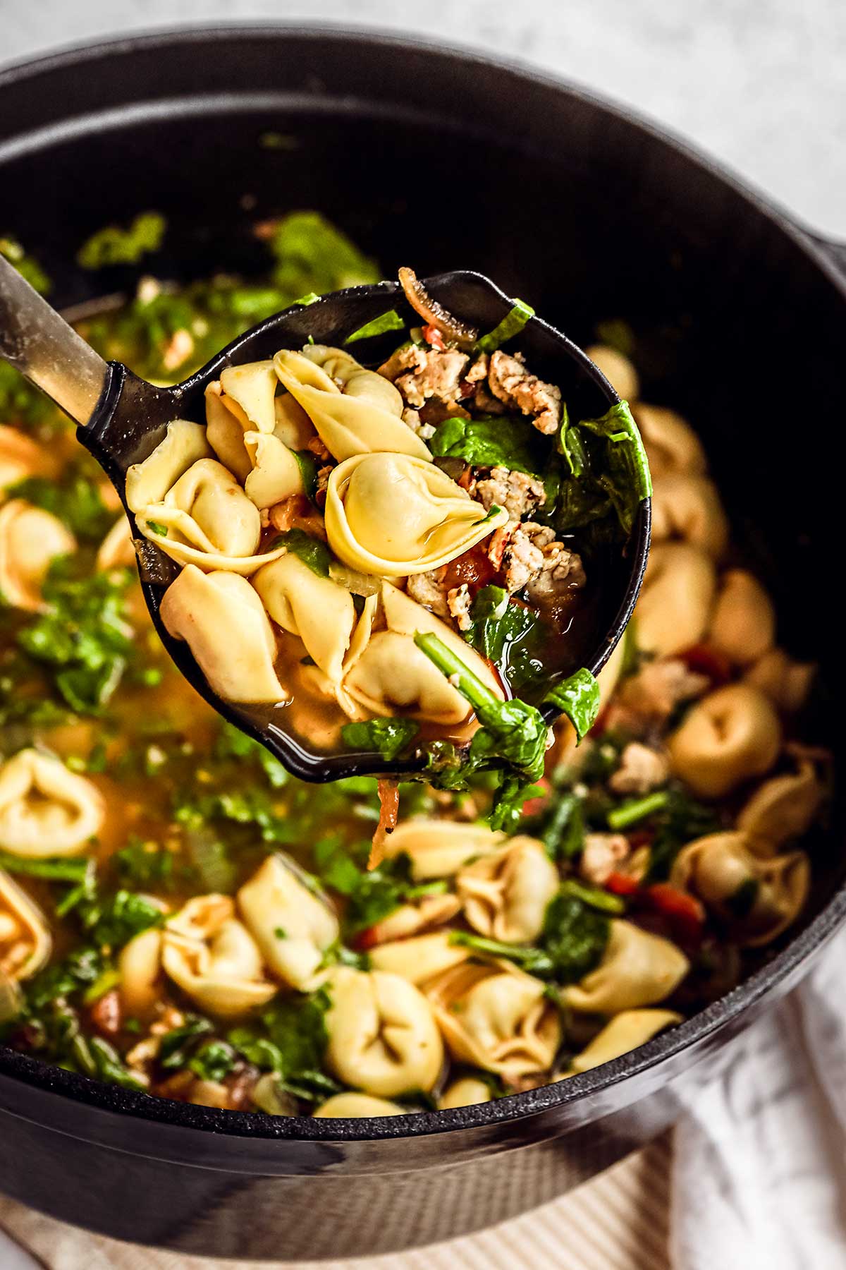 Italian Sausage Tortellini Soup in pot and ladle