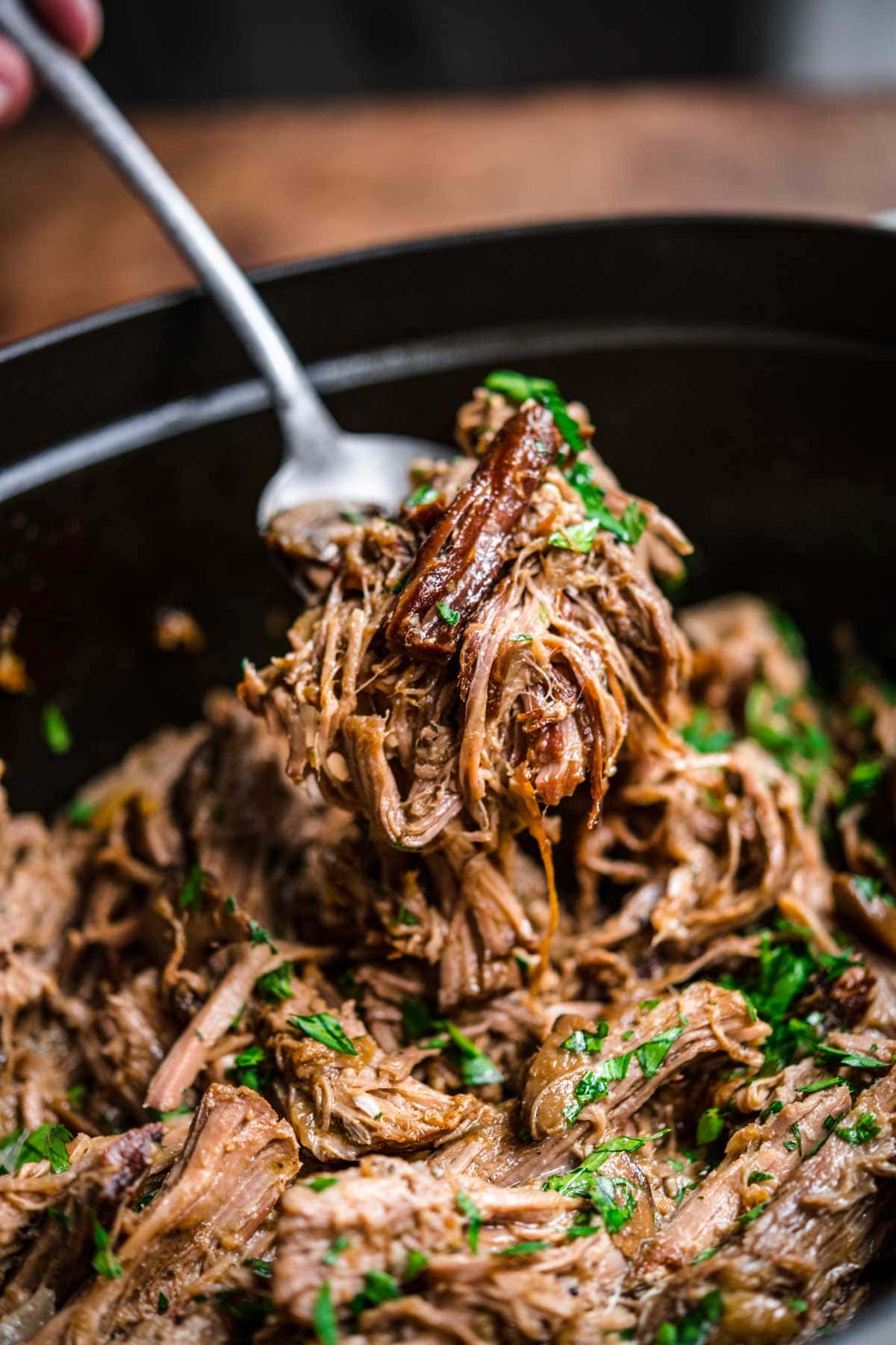 Mushroom Beef Roast shredded and garnished with fresh parsley