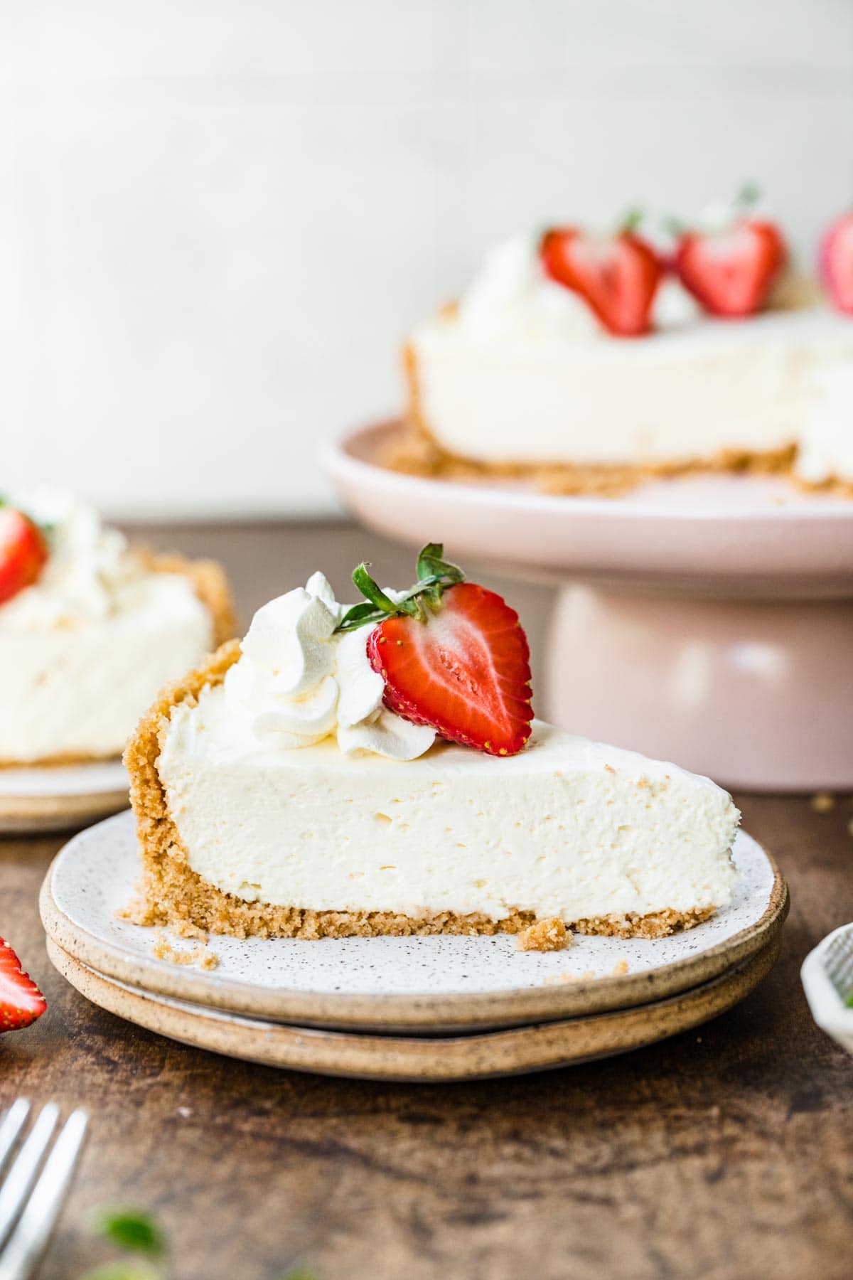 No-Bake Cheesecake sliced with fresh strawberry garnish