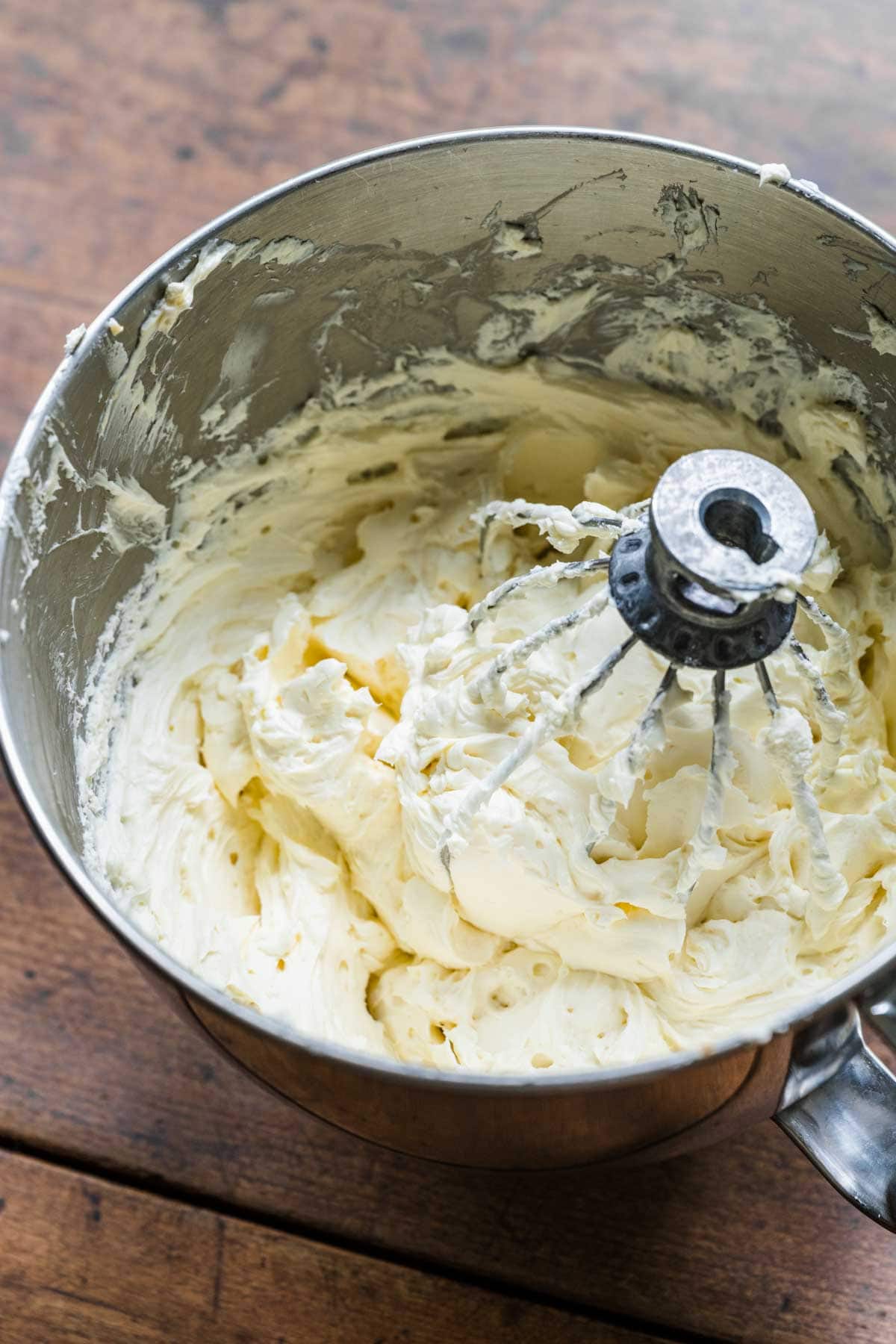 Cream Cheese mixture in mixing bowl with whisk attachment for No-Bake Cheesecake