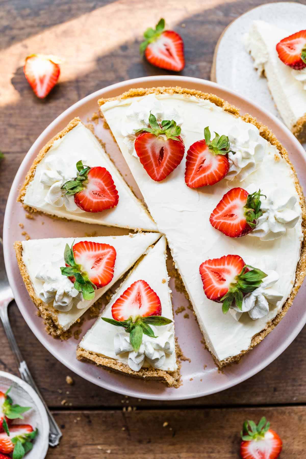 No-Bake Cheesecake sliced with fresh strawberry garnish