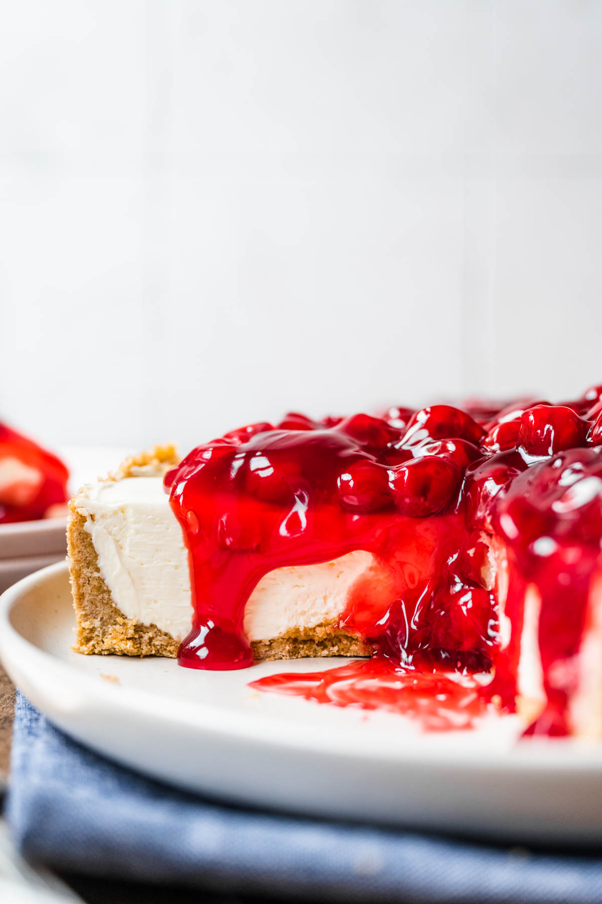 No Bake Cherry Cheesecake on serving plate with slice removed