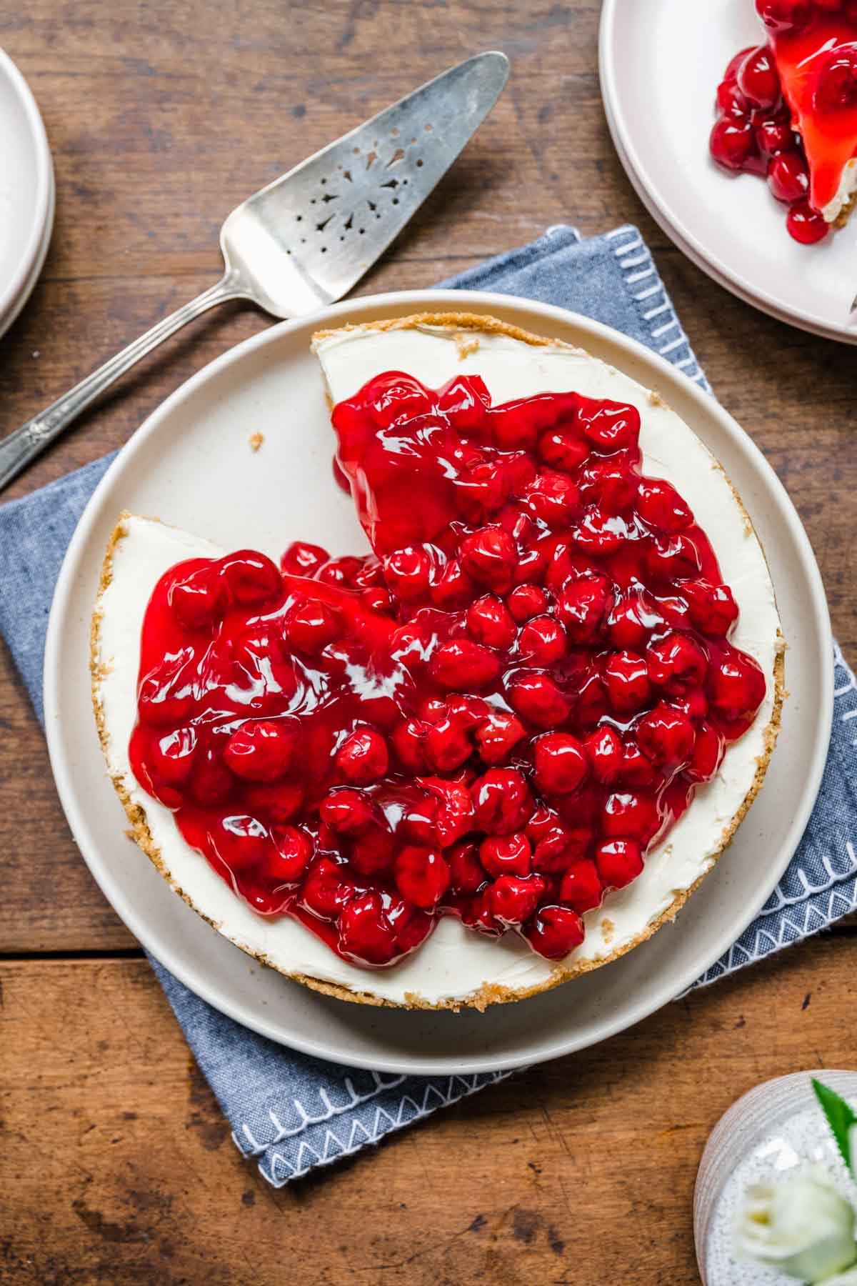 No Bake Cherry Cheesecake on serving plate with slice removed