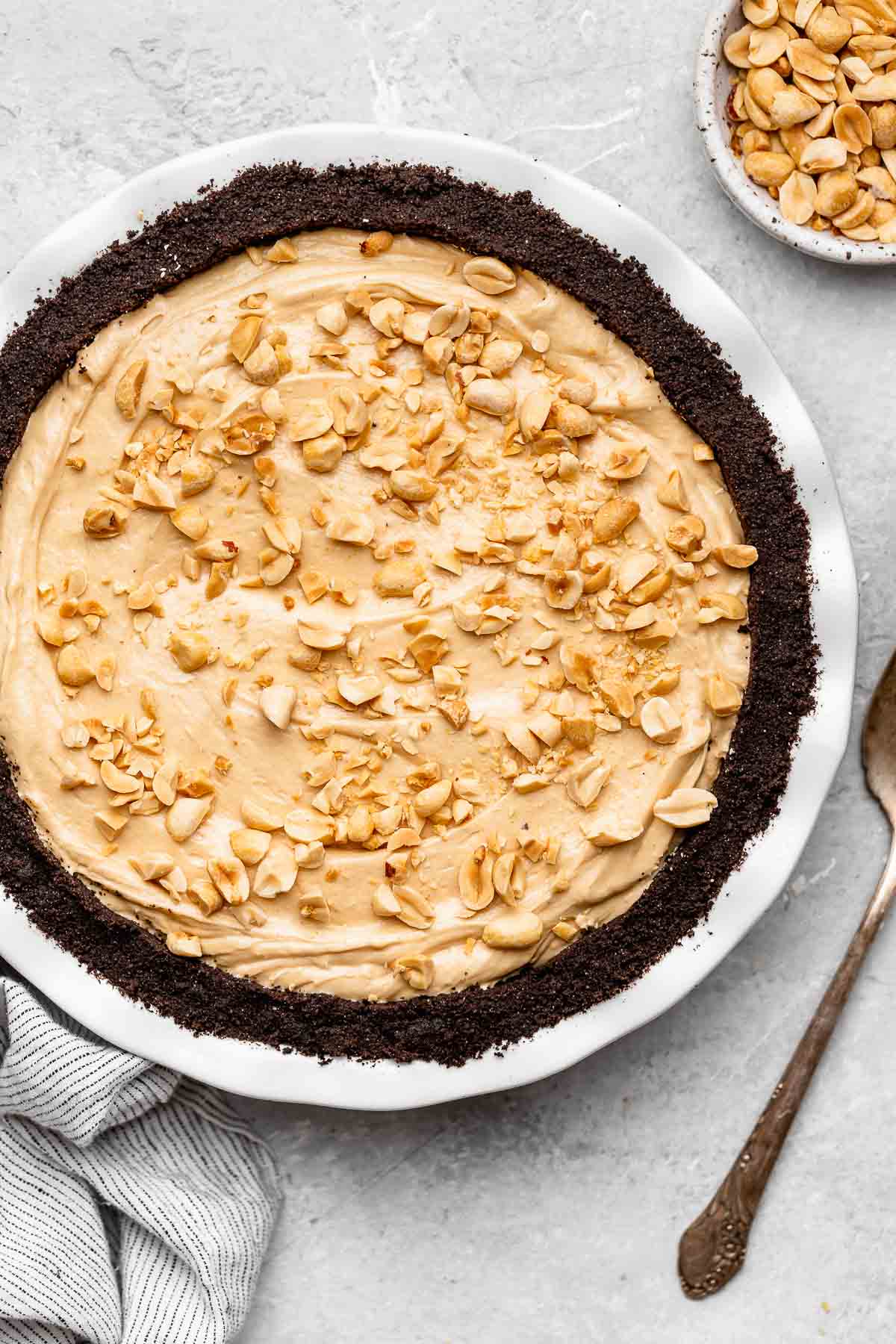 Oreo Peanut Butter Whip Pie in pie dish with chopped peanuts on top