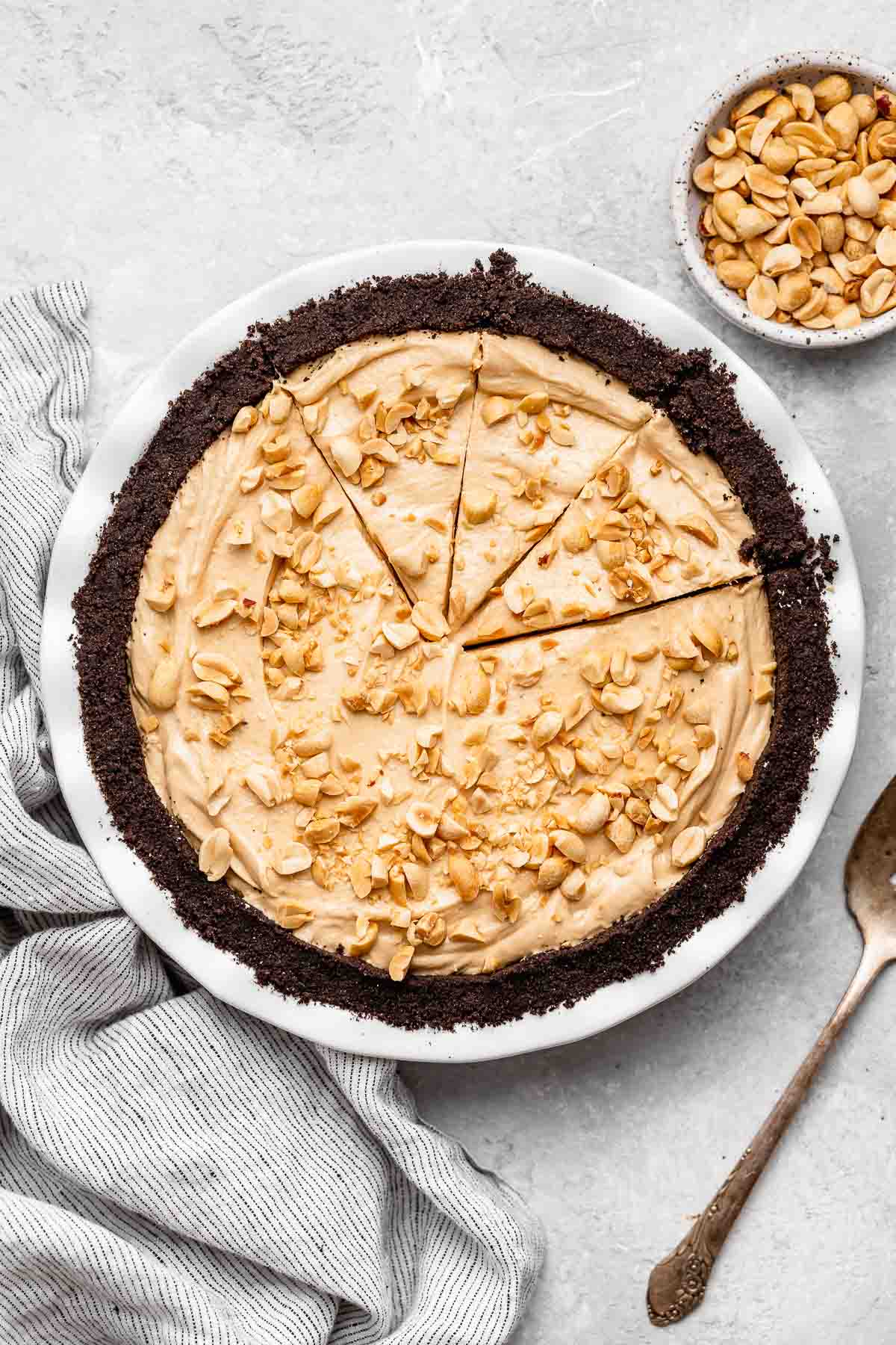 Oreo Peanut Butter Whip Pie in pie dish with chopped peanuts on top