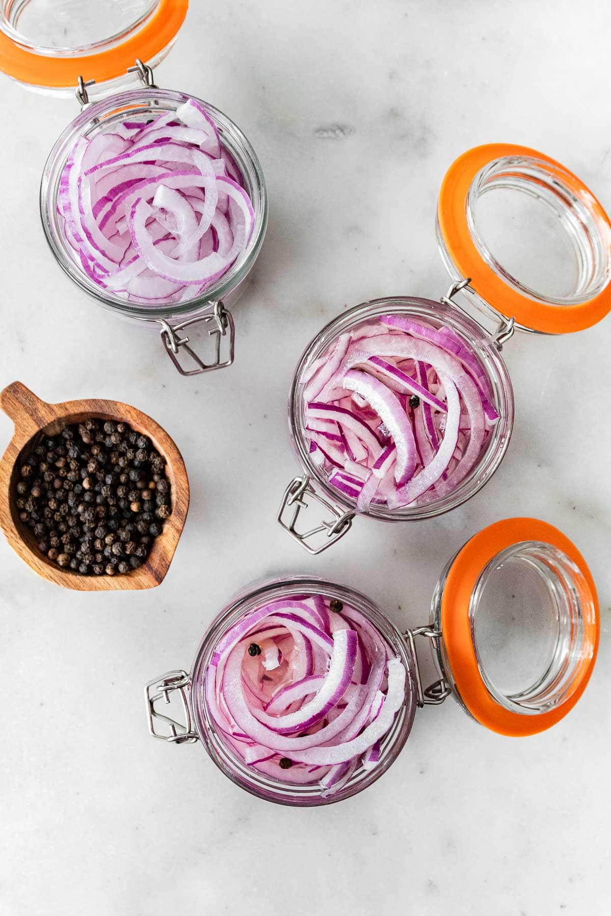 Sliced onions in canning jars for Pickled Red Onions