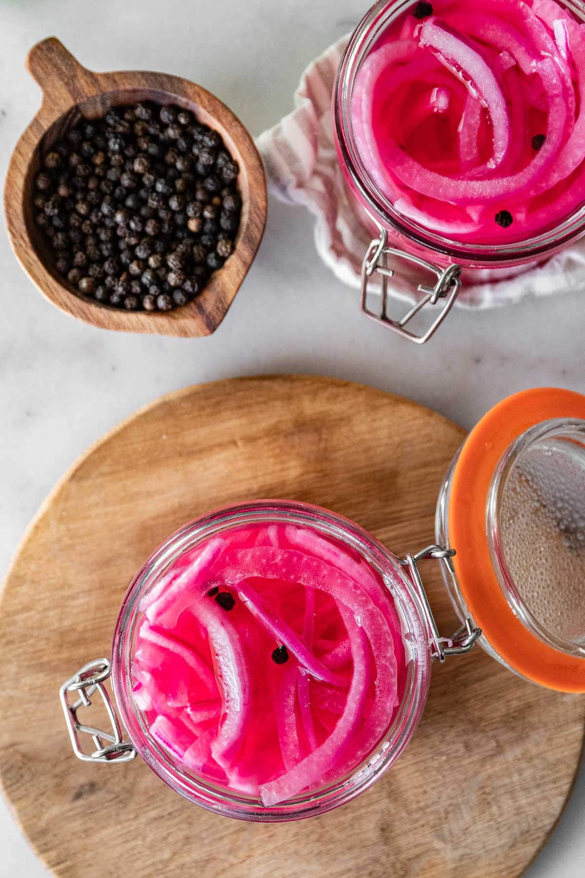 Pickled Red Onions in jar on cutting board