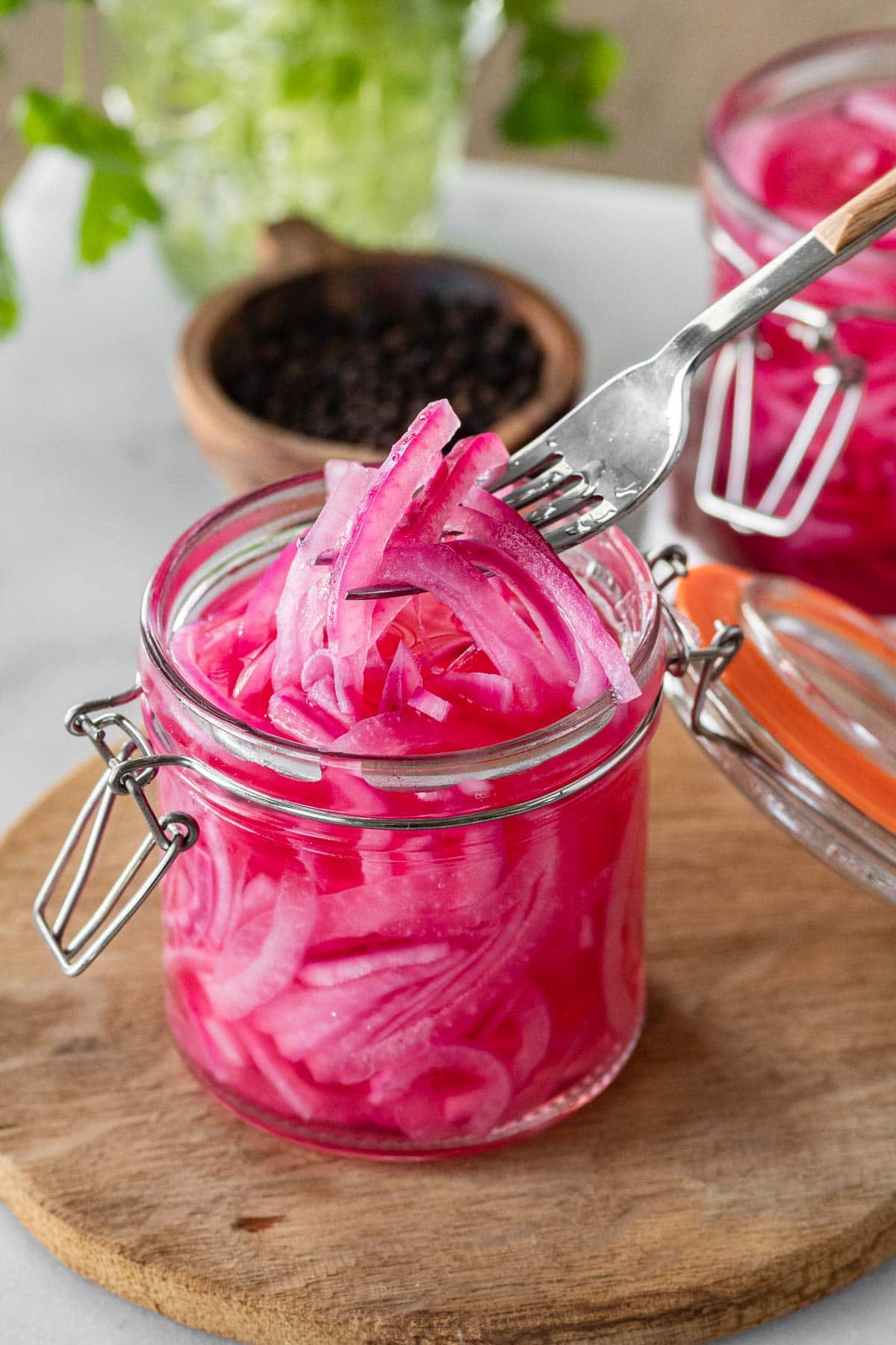 Pickled Red Onions in jar on cutting board