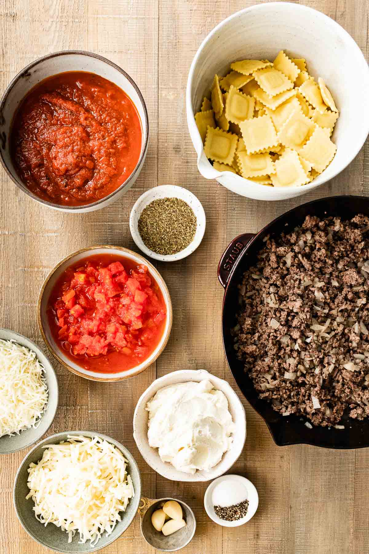 Ingredients in prep bowls for Ravioli Lasagna Bake