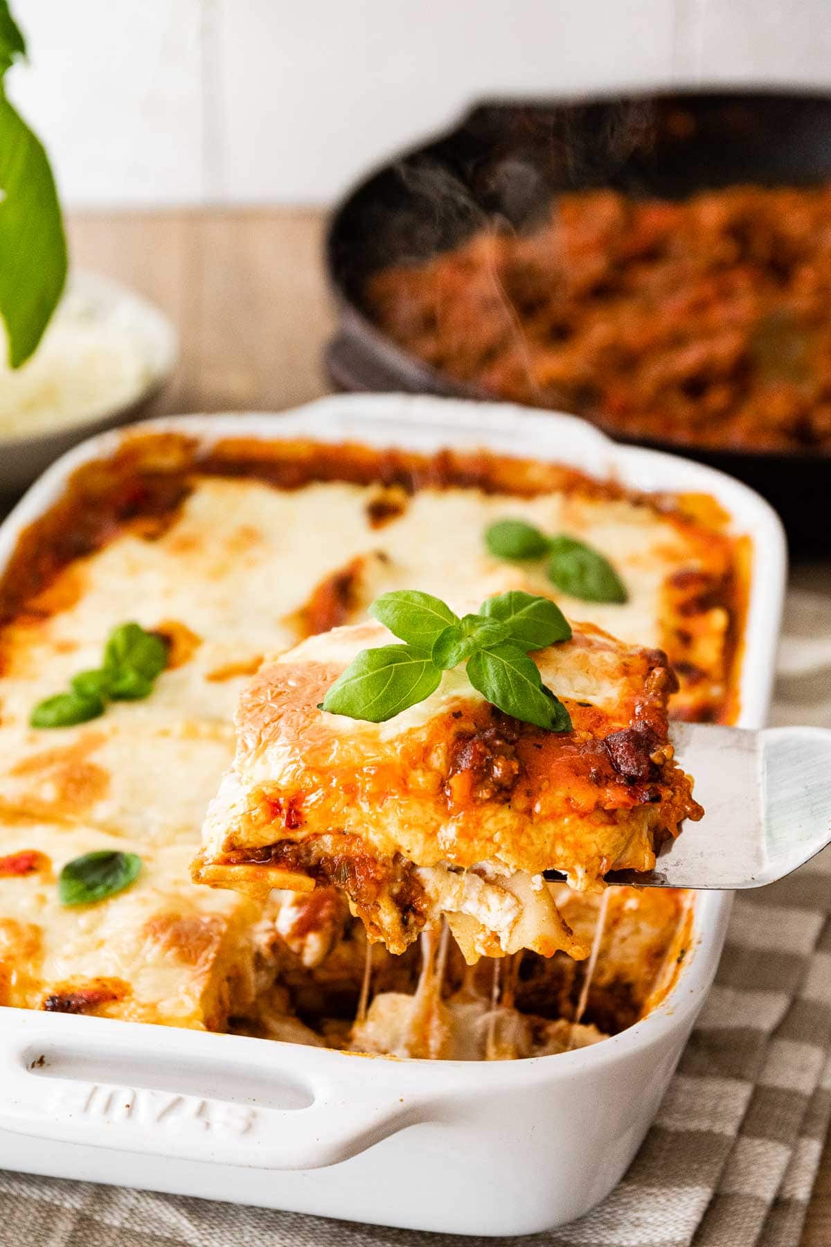 Ravioli Lasagna Bake in baking dish with serving spatula