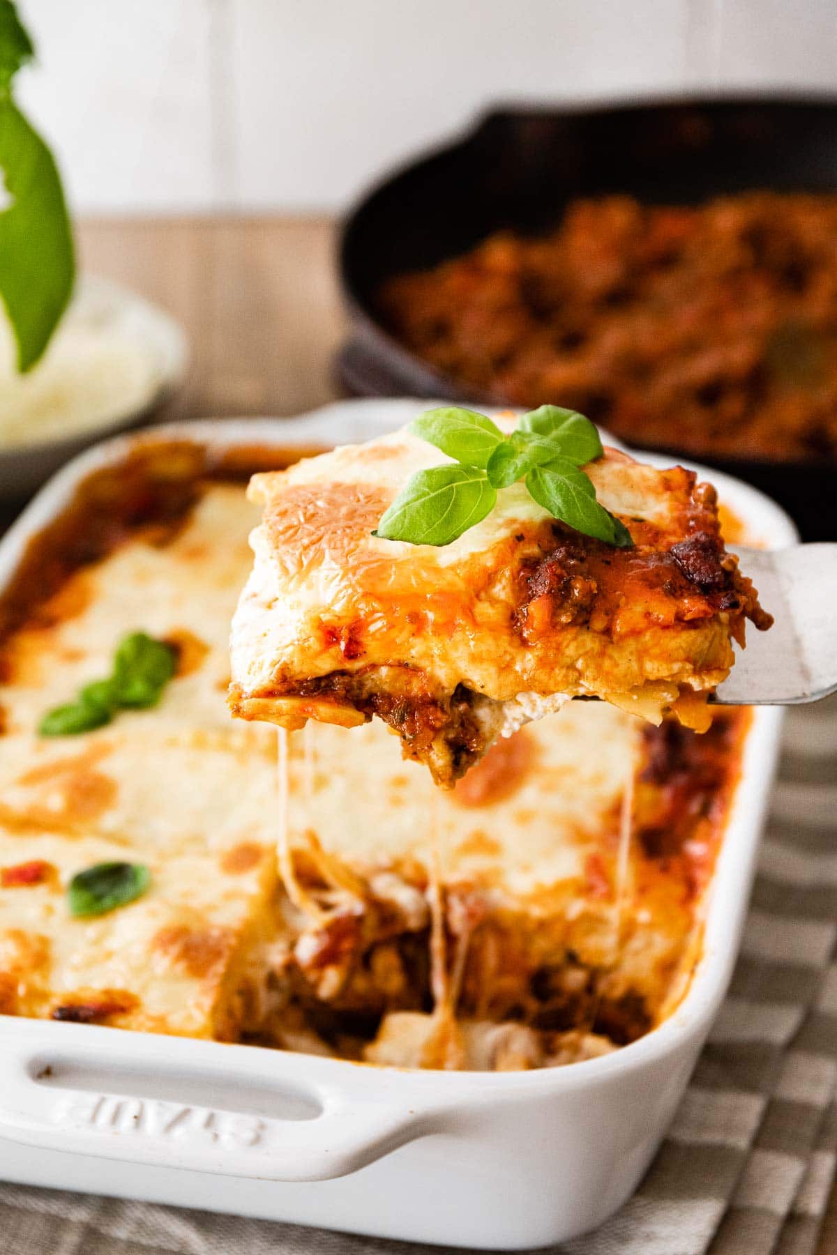 Ravioli Lasagna Bake in baking dish with serving spatula