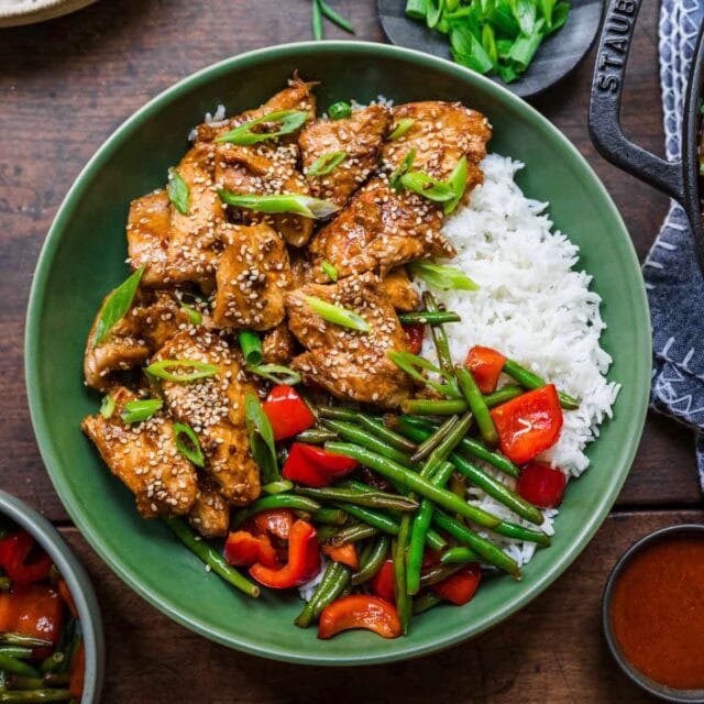 Skillet Sesame Chicken on a plate with rice and veggies