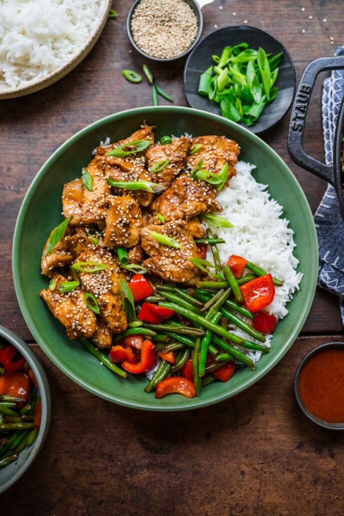 Skillet Sesame Chicken on a plate with rice and veggies