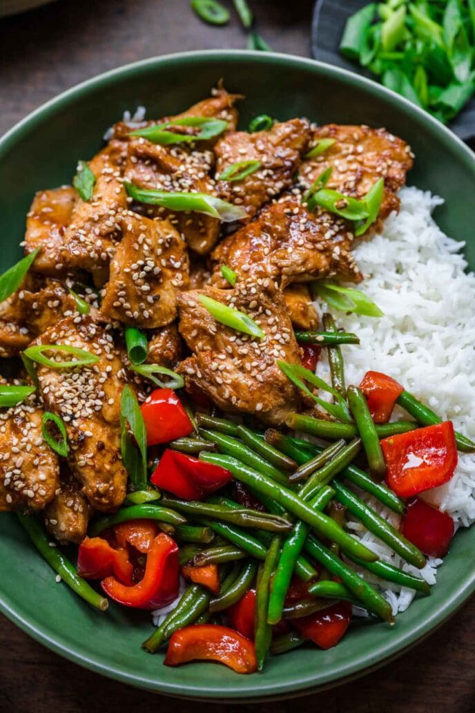 Skillet Sesame Chicken on a plate with rice and veggies