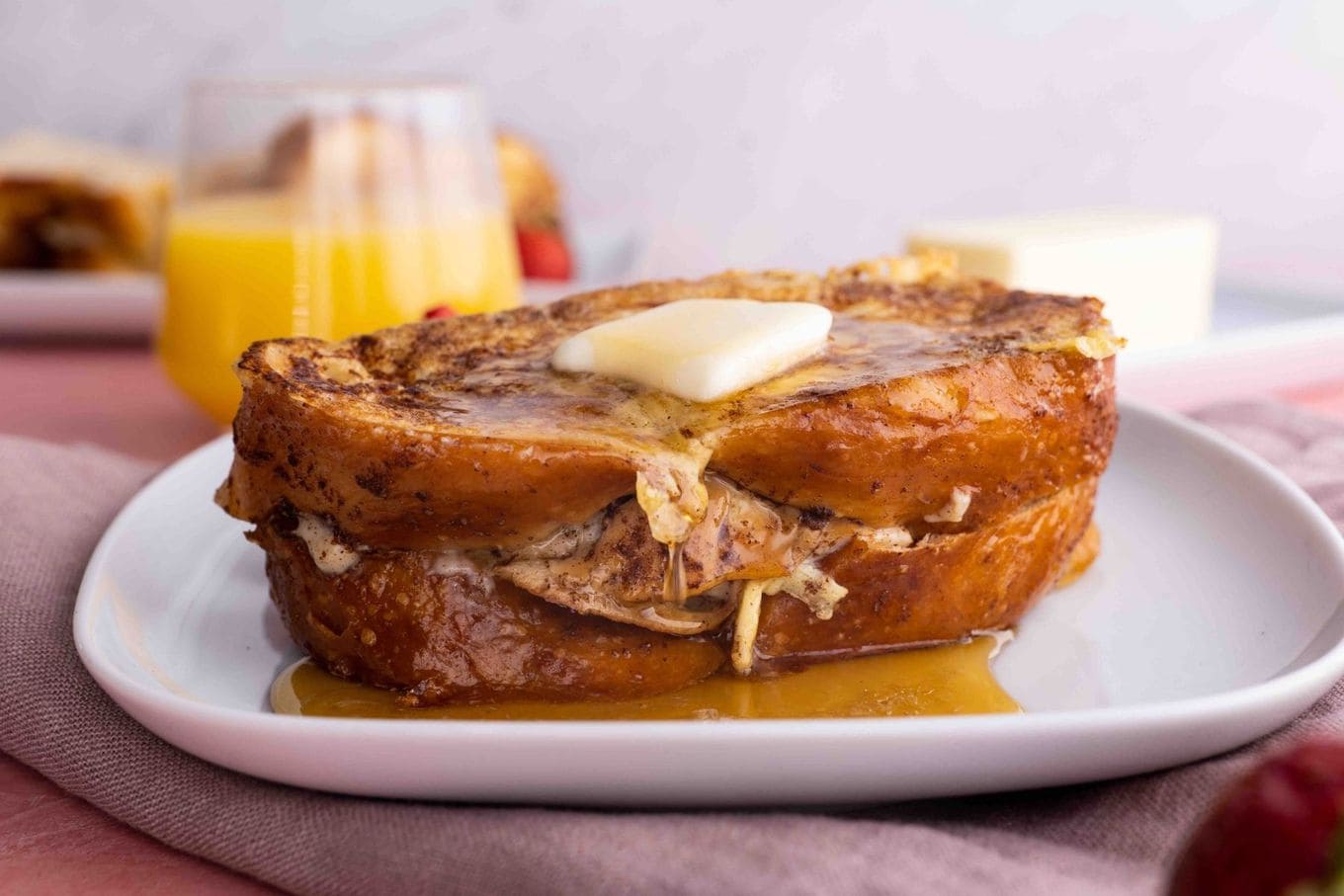 Stuffed French Toast on plate with butter and syrup