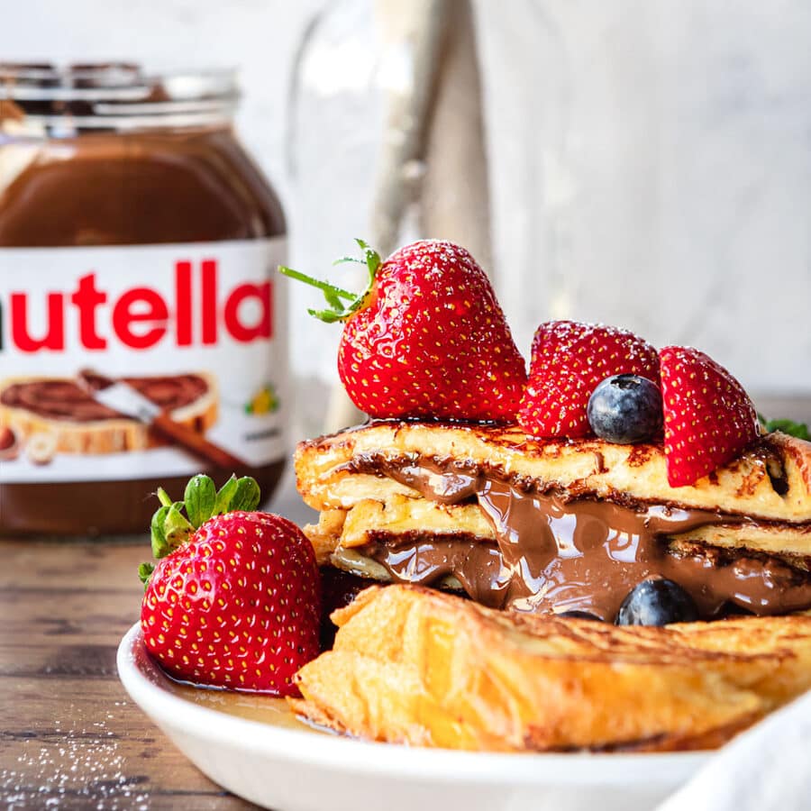 Stuffed Nutella French Toast with berries on top and Nutella Jar