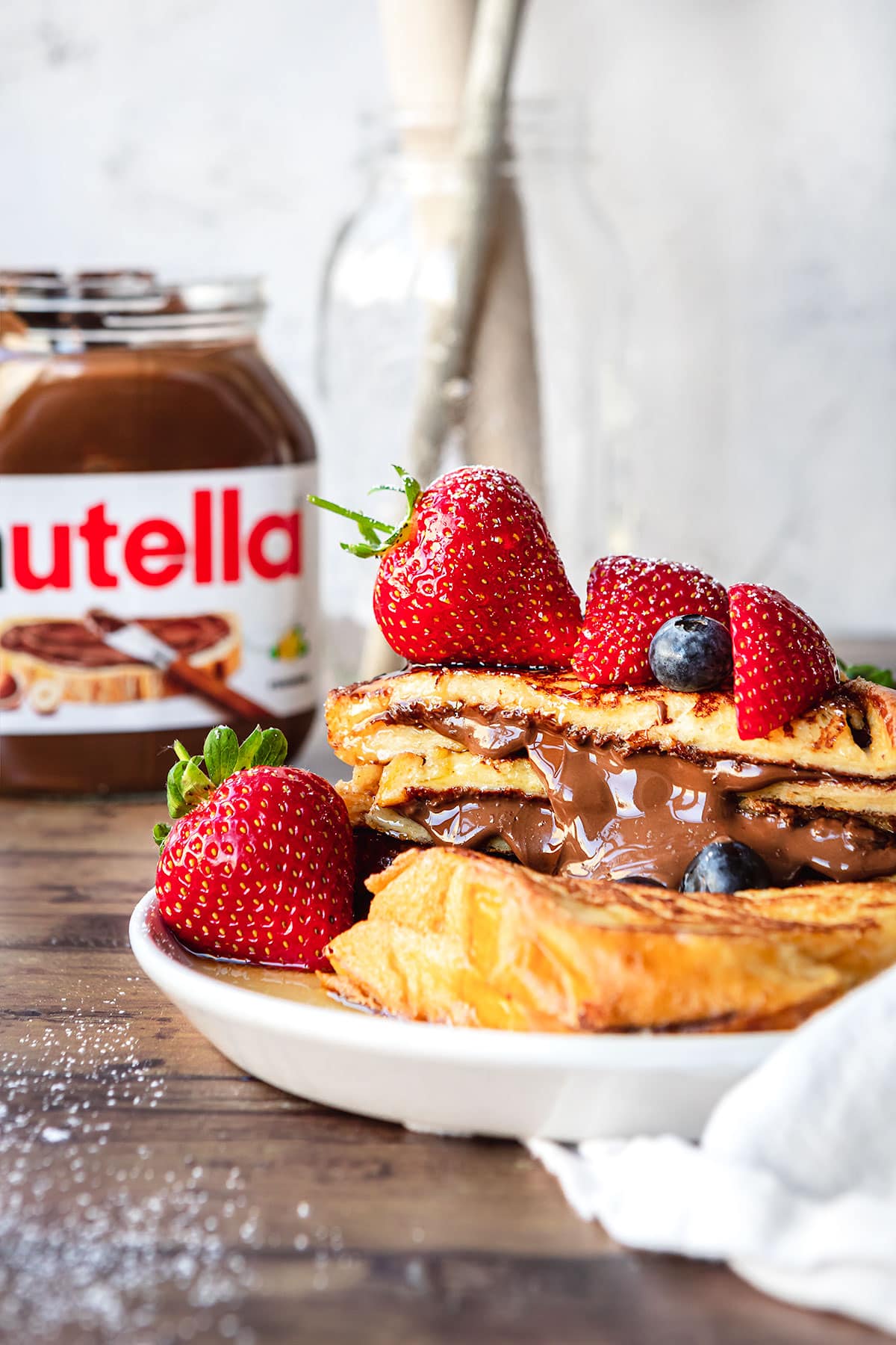 Stuffed Nutella French Toast with berries on top and Nutella Jar