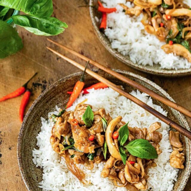 Thai Basil Chicken over rice on a plate