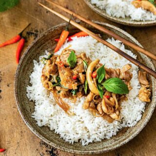 Thai Basil Chicken over rice on a plate