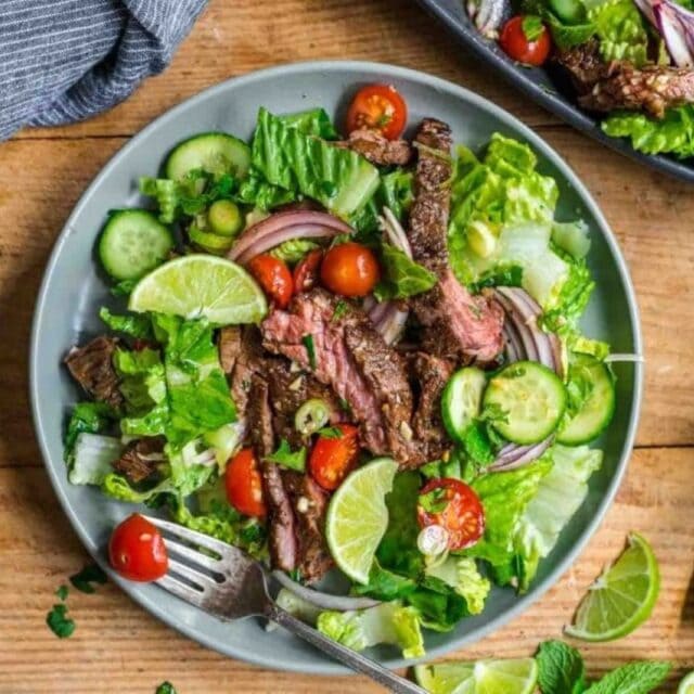 Salad in a bowl with a fork on the side.