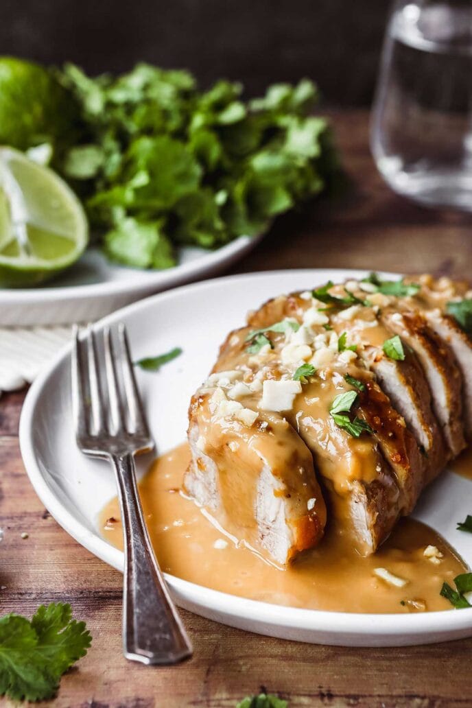 Thai Peanut Pork Tenderloin sliced with sauce on plate