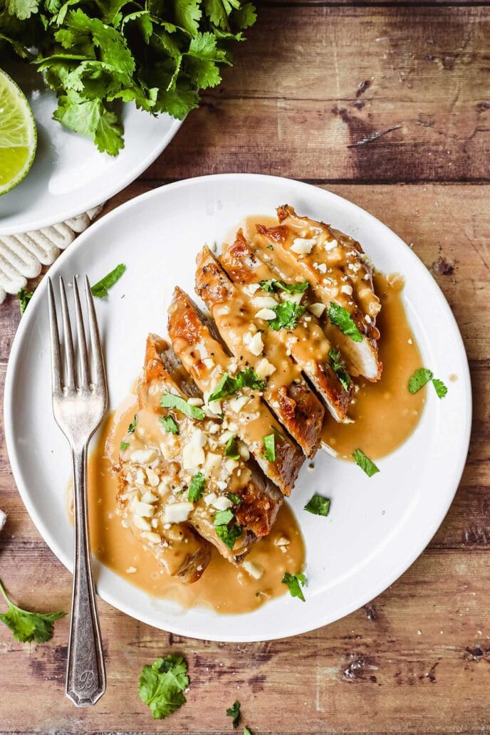 Thai Peanut Pork Tenderloin sliced with sauce on plate