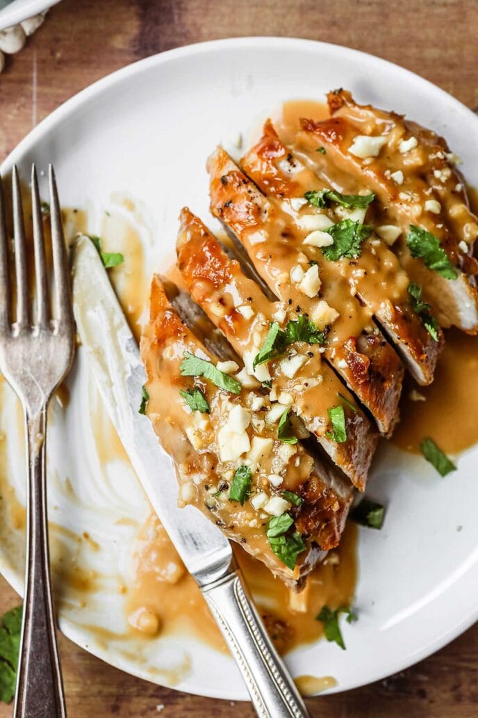 Thai Peanut Pork Tenderloin sliced with sauce on plate