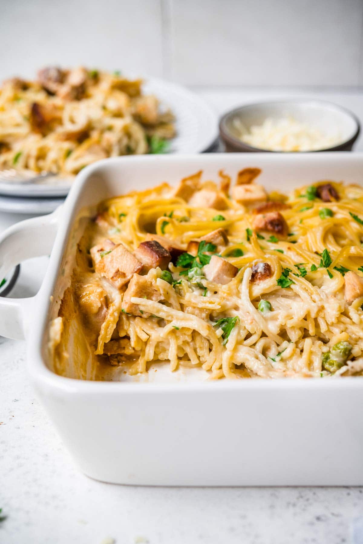 Turkey Tetrazzini in baking dish with fresh parsley garnish