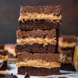 Stacked Crispy Chocolate Peanut Butter Brownie Bars on cutting board